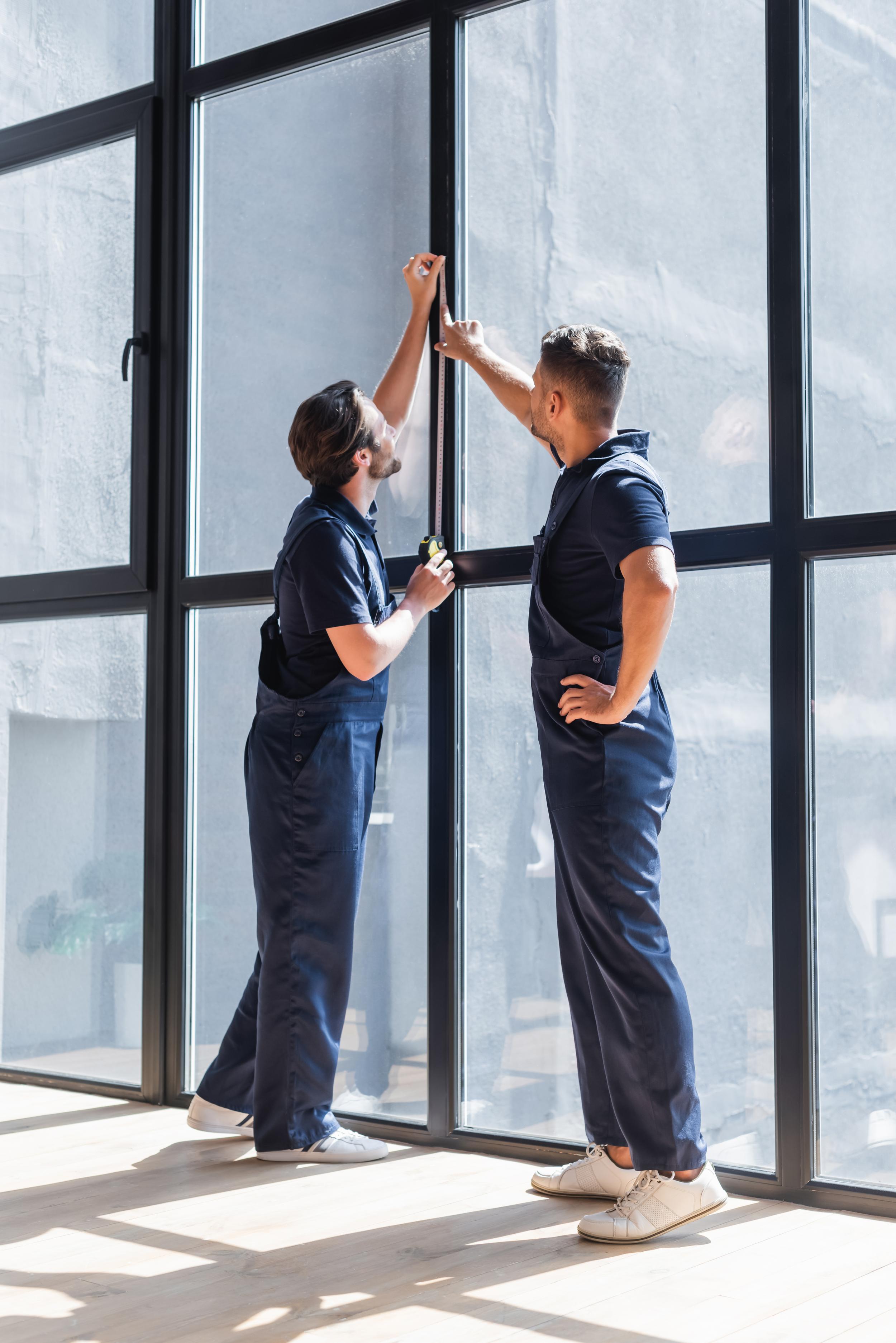 workers-measure-window-with-tape-inside-building-2026-03-11-03-16-31-utc.jpg
