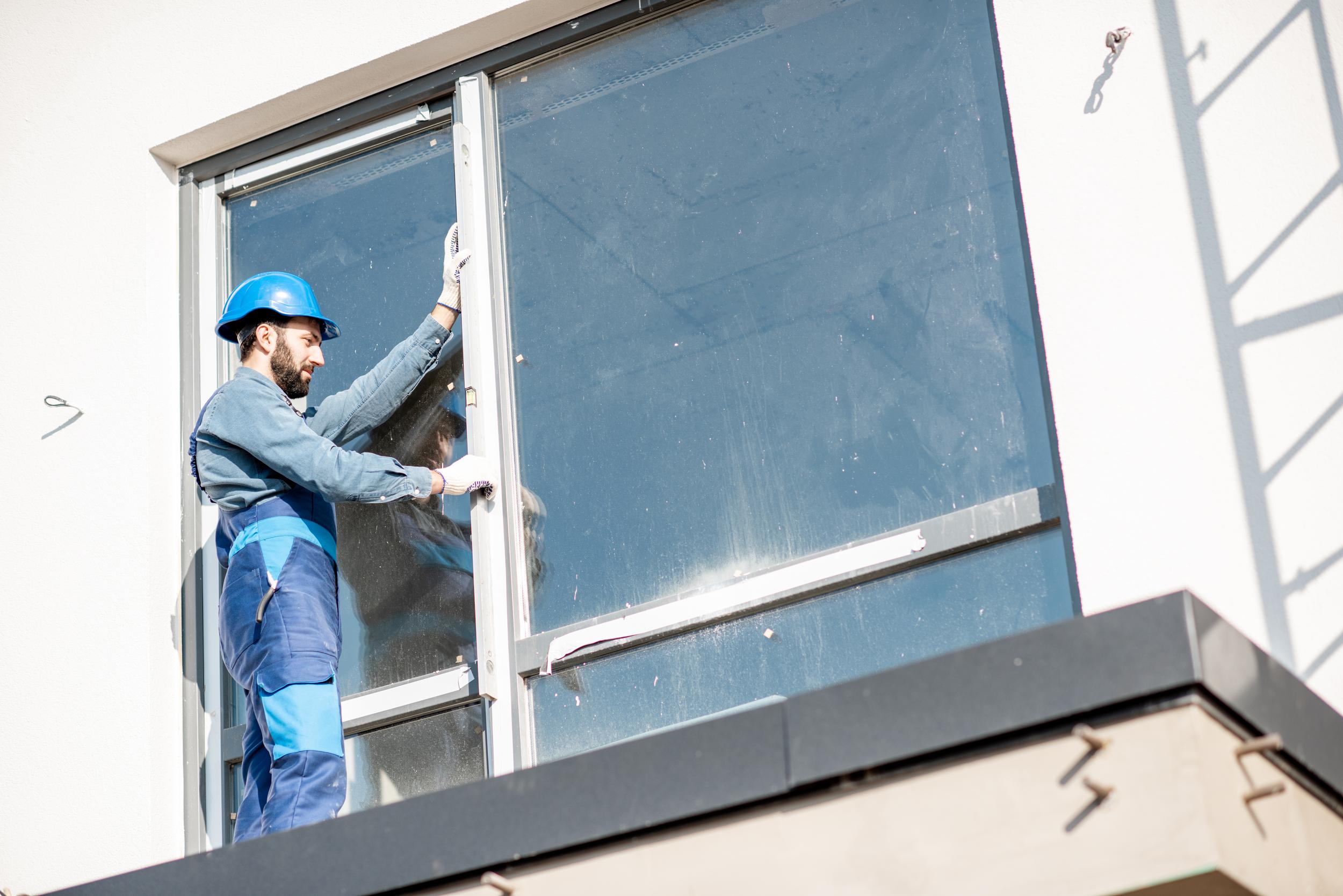 construction-worker-installing-large-window-on-bui-2026-03-25-00-55-45-utc.jpg