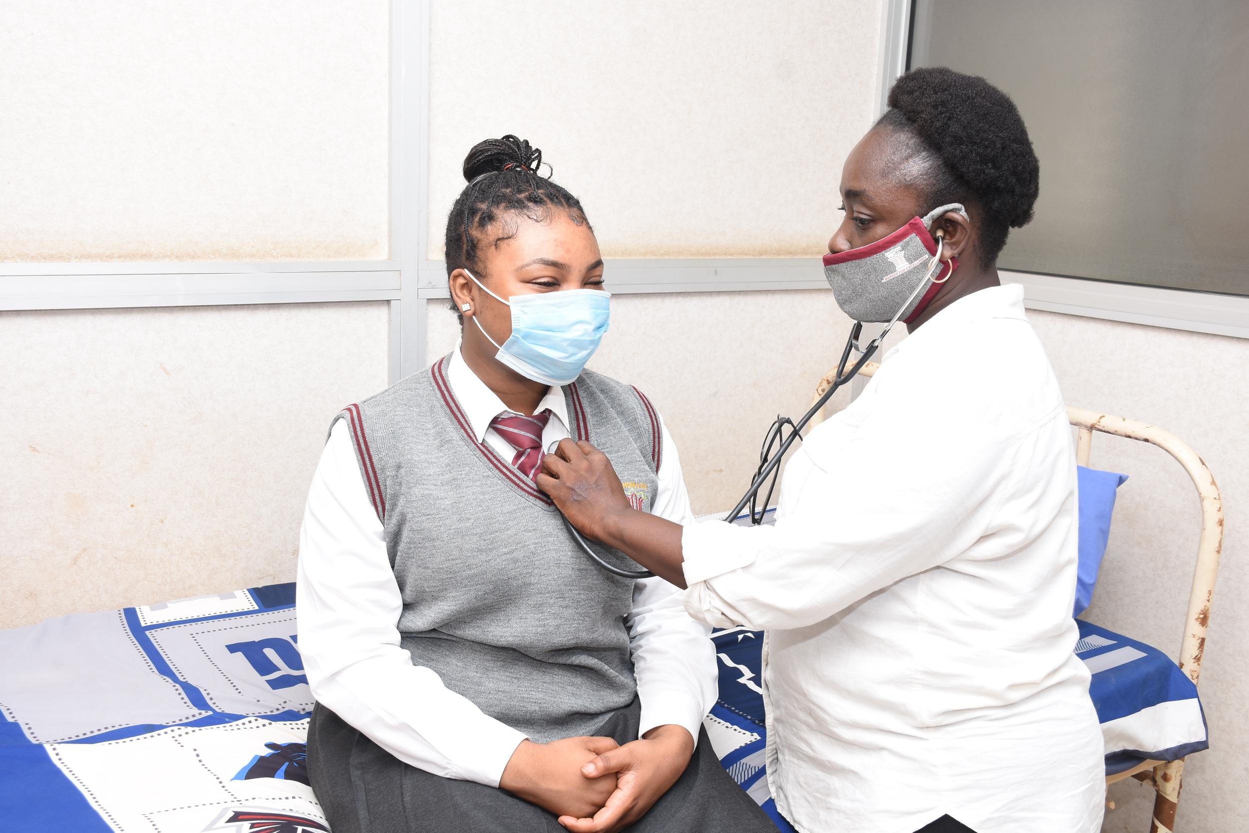 A nurse checking on her patient.