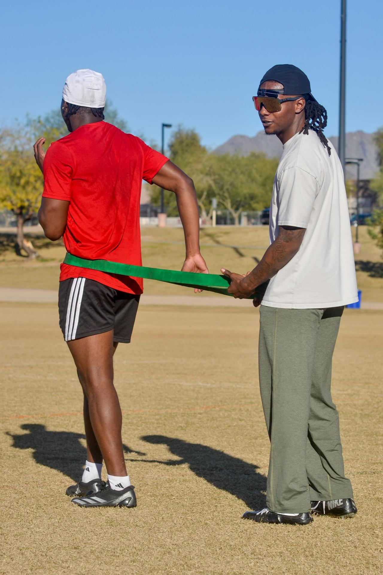 Men engaged in football training with resistance band outdoors in Scottsdale, Arizona.