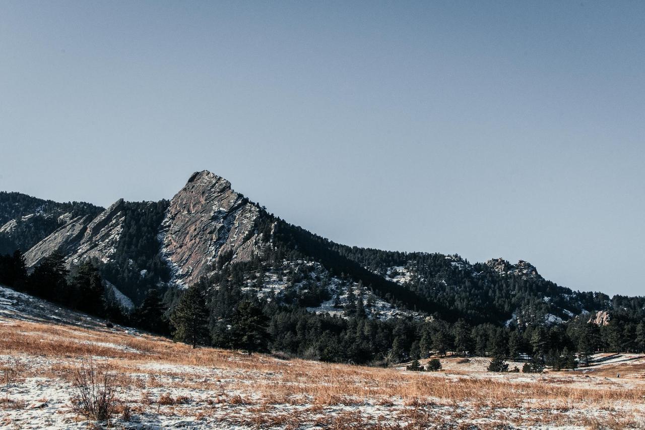 Breathtaking view of a snow-dusted mountain during winter, captured at sunrise.