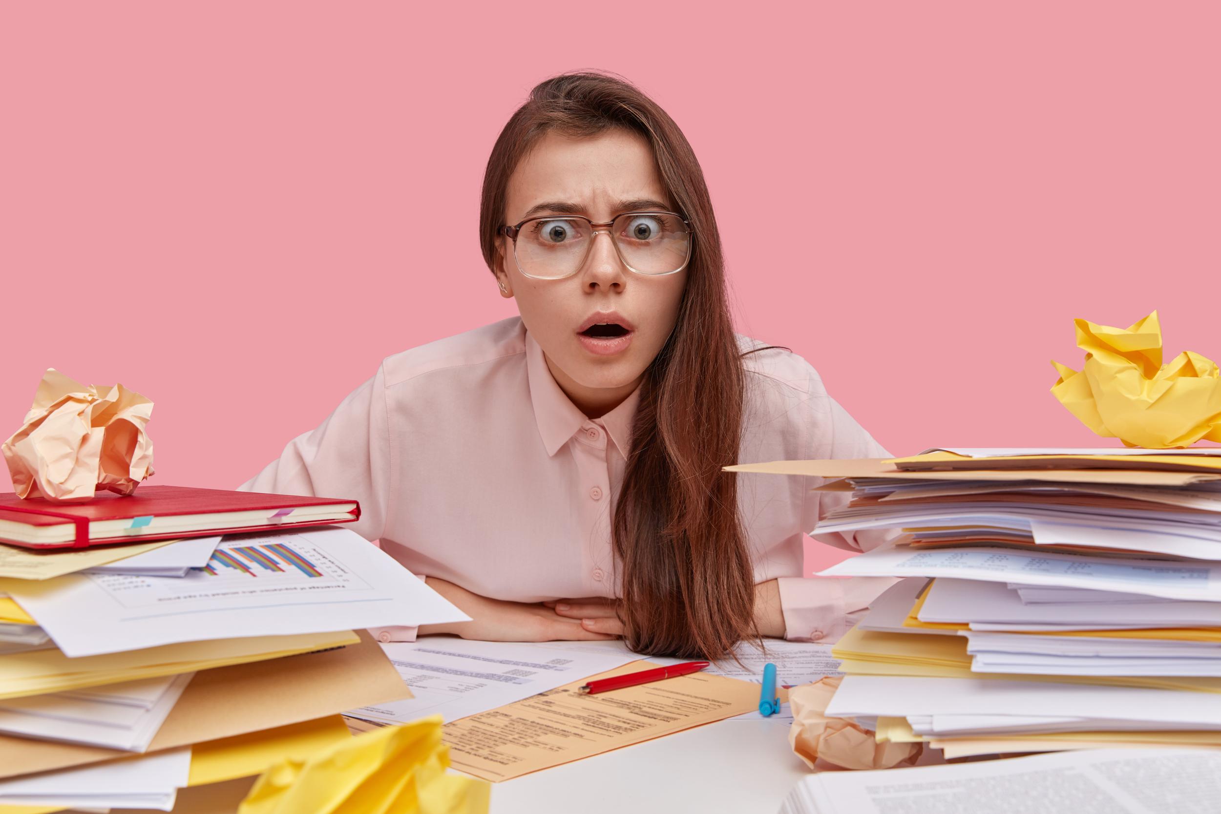 overwhelmed-young-woman-in-office-with-paperwork-2026-03-17-02-54-55-utc.jpg