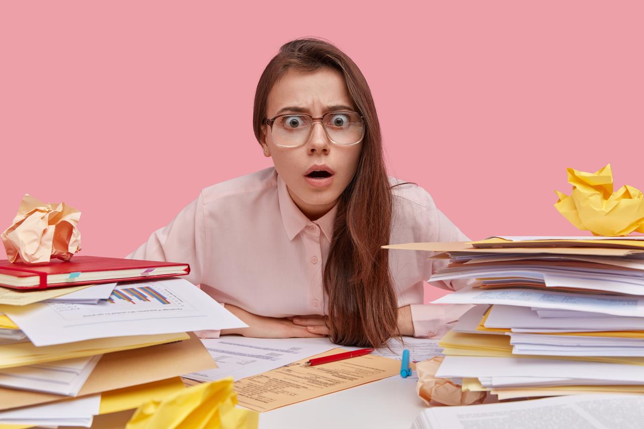 overwhelmed-young-woman-in-office-with-paperwork-2026-03-17-02-54-55-utc.jpg