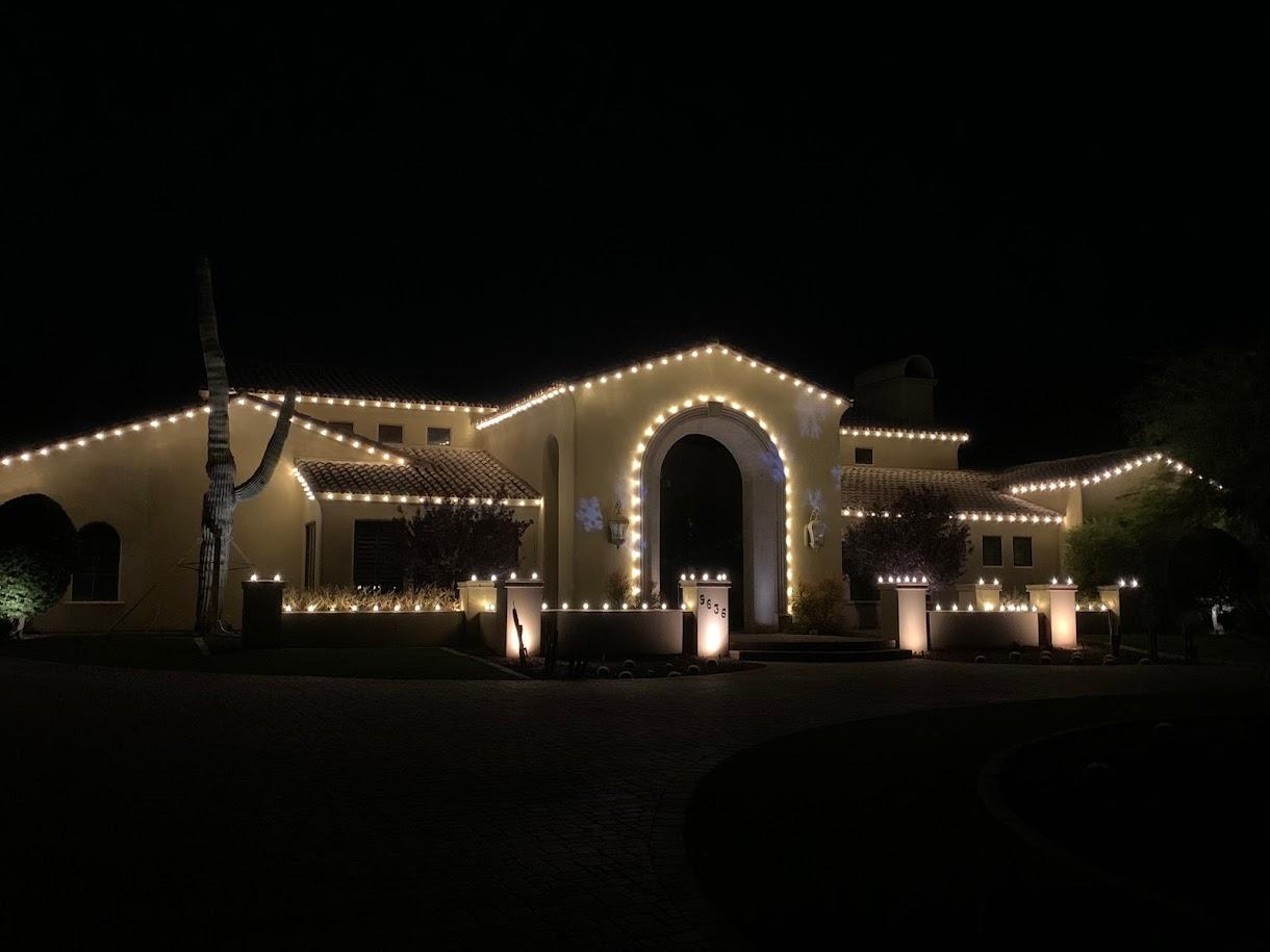 Southwest home with elegant arched doorway decorated with garland