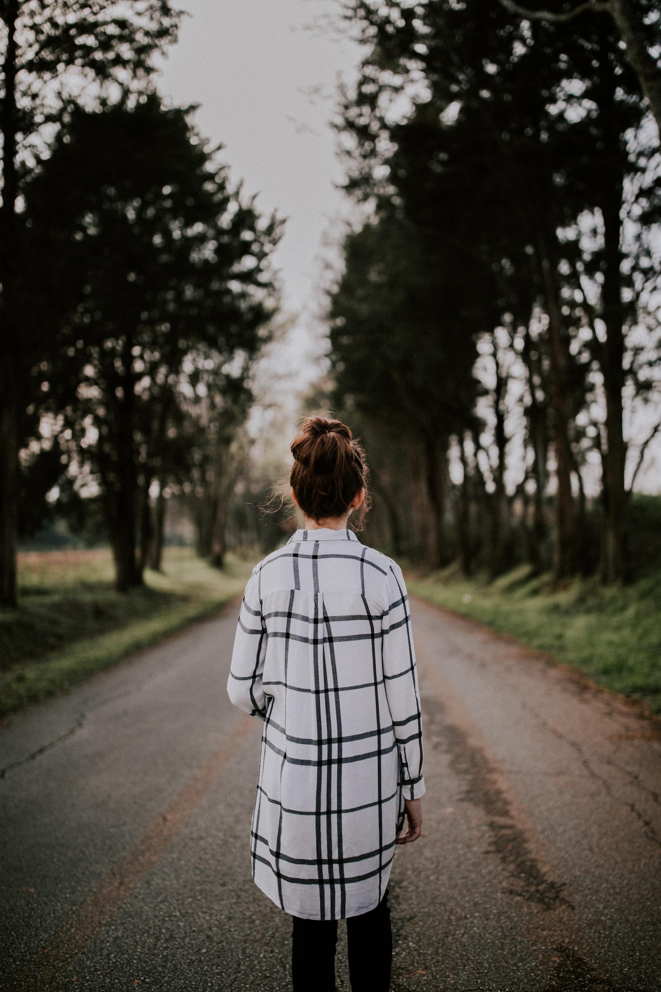 girl walking on in middle of road