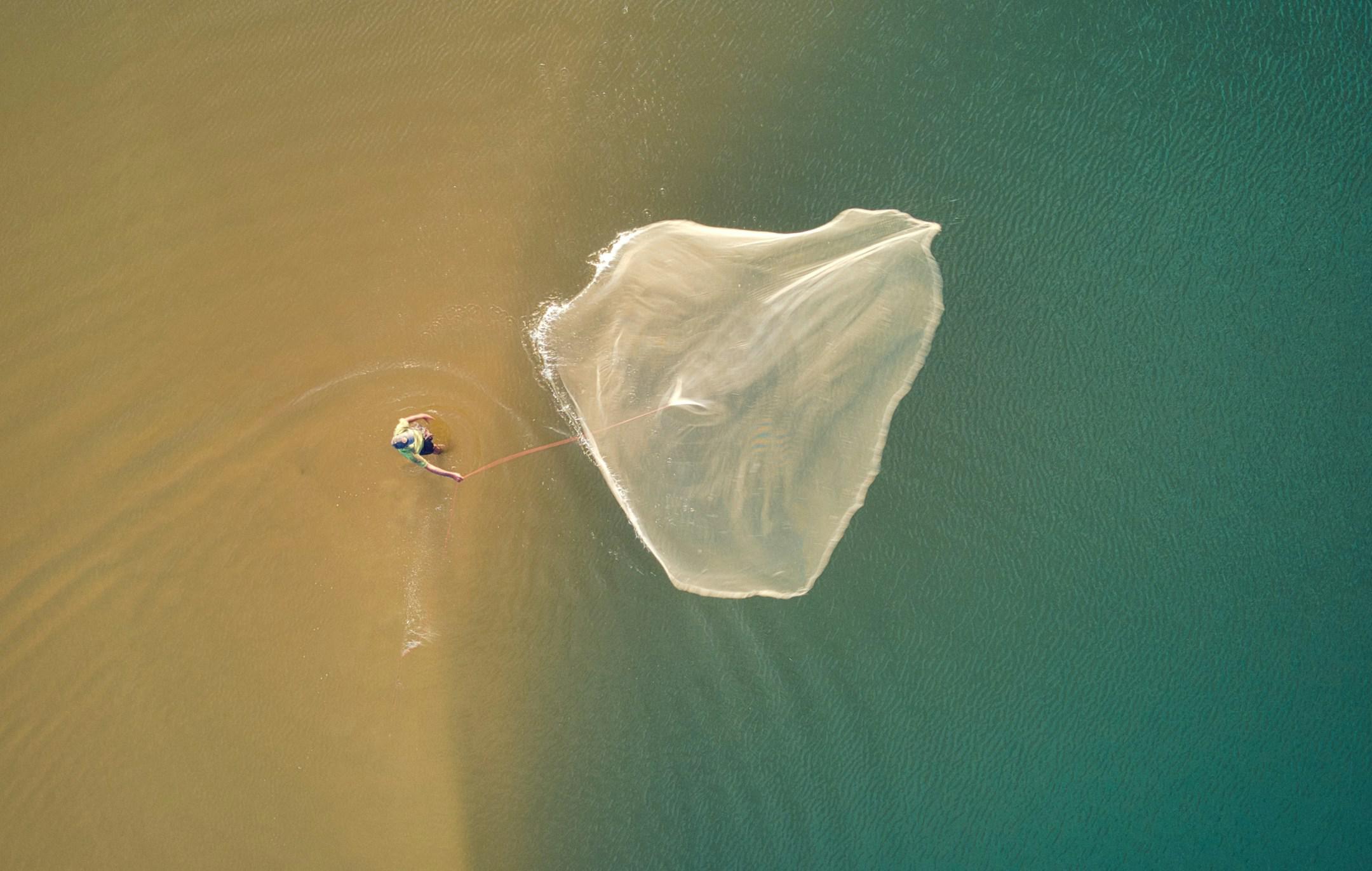 Man Throwing A Fishing Net