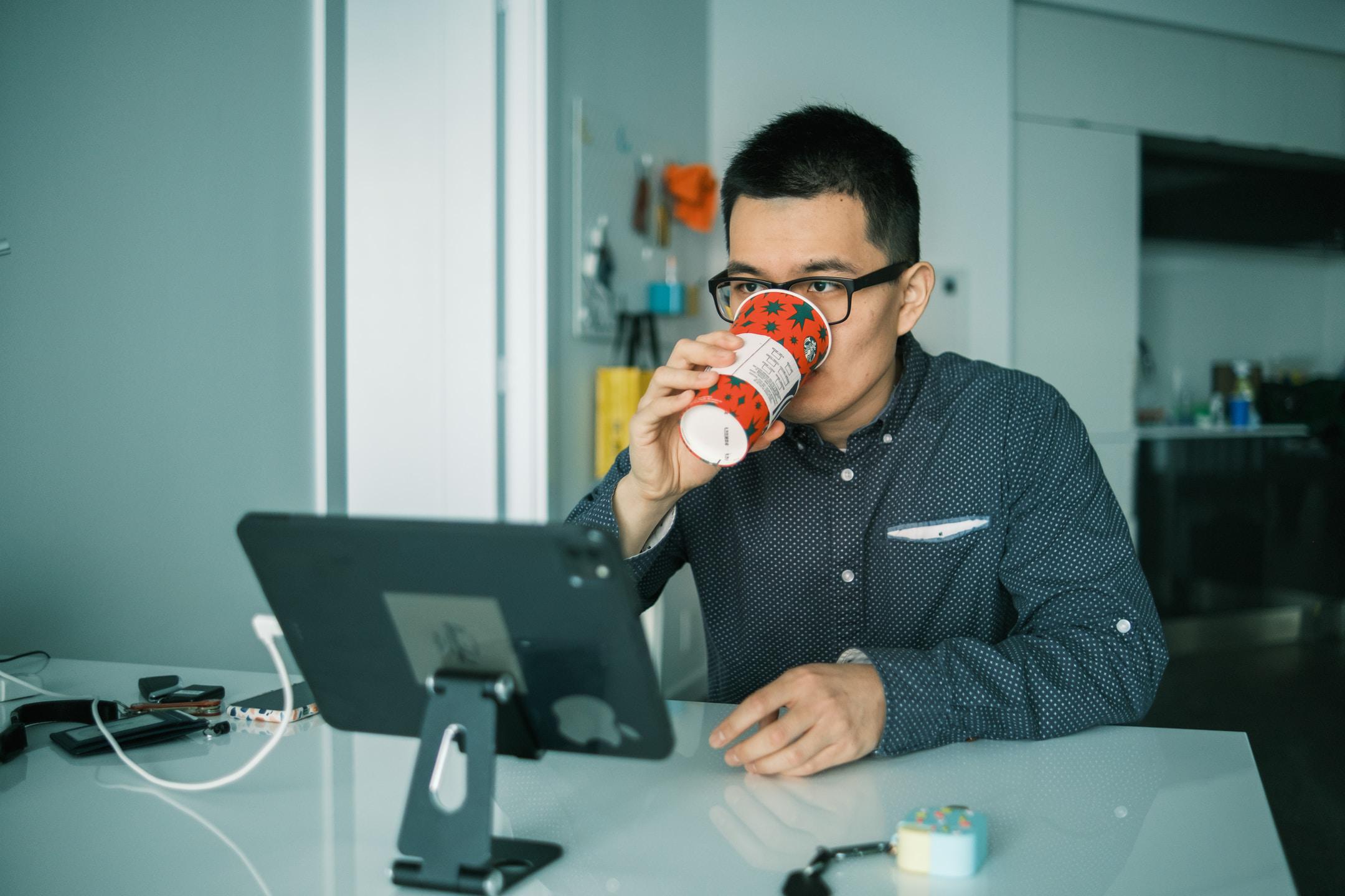 Man drinking coffee a a desk