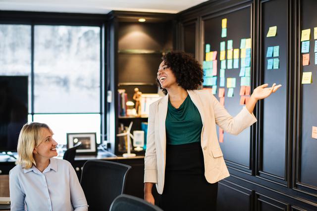 two women interacting in a work environment, symobolizing helping to find jobs for people with disabilities