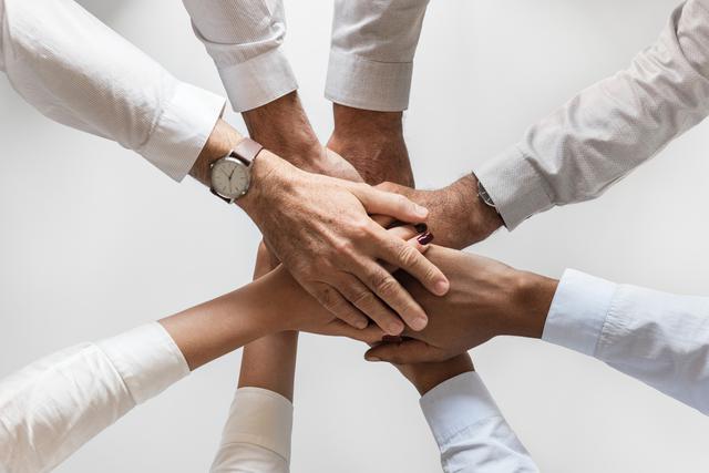 a circle of hands joined together, symobolizing helping find jobs for people with disabilities