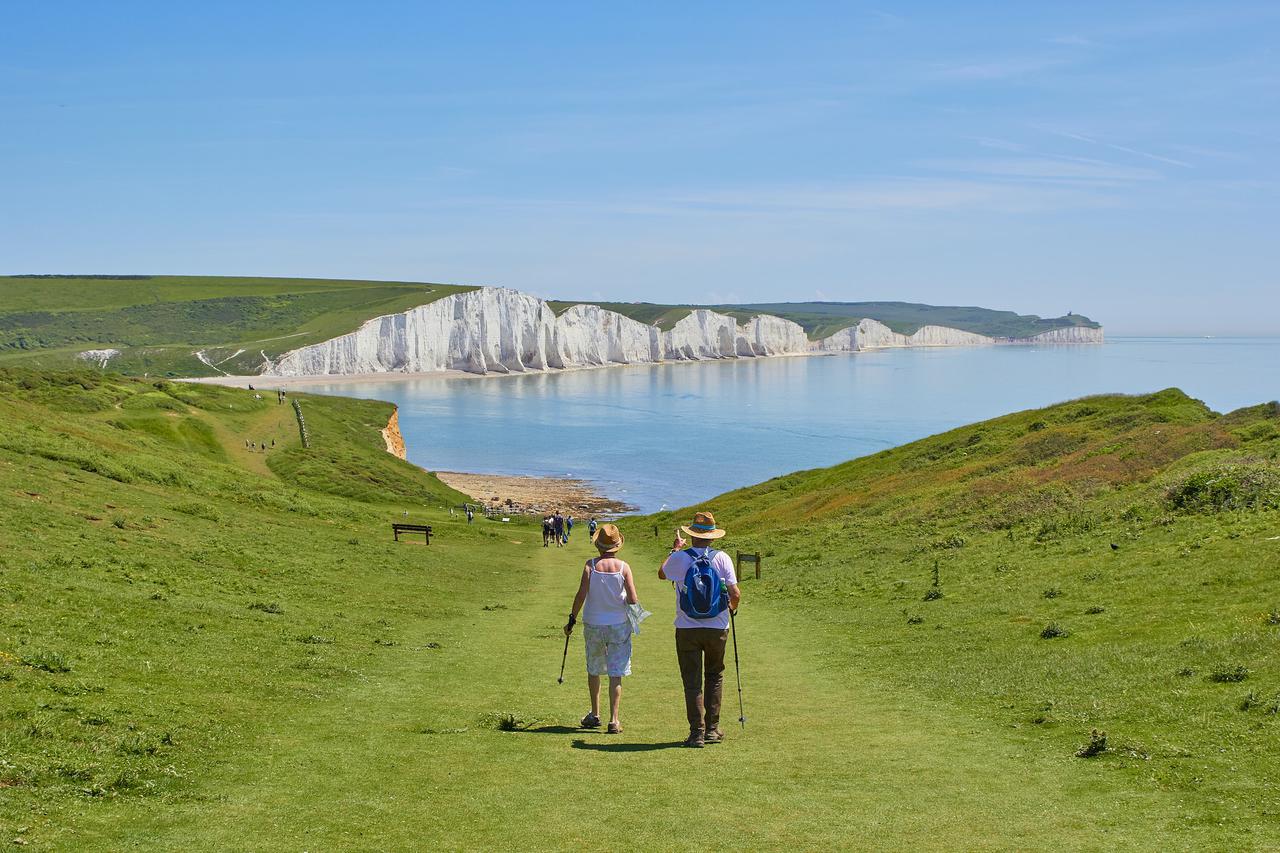 An old couple walking towards the Seven Sisters