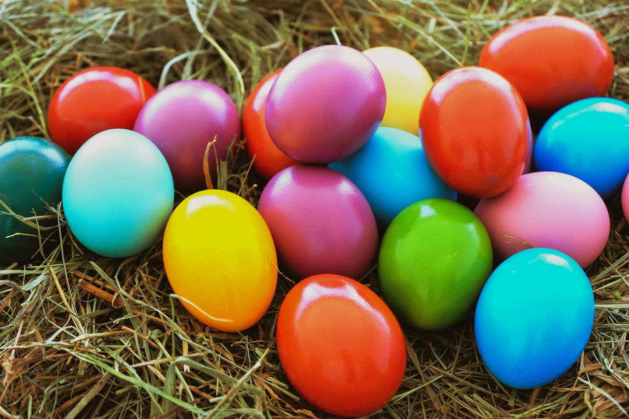 Colorful painted Easter eggs arranged on straw, capturing festive and vibrant springtime celebration mood.
