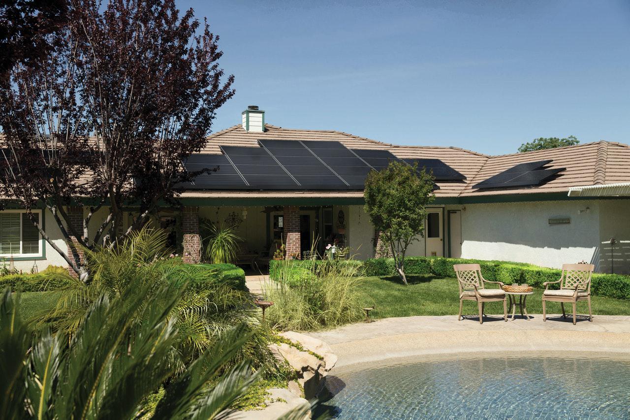 A beautiful home with a pool and solar panels. Solar panels in Maryland will save you money, enabling you to make dream additions to your property.