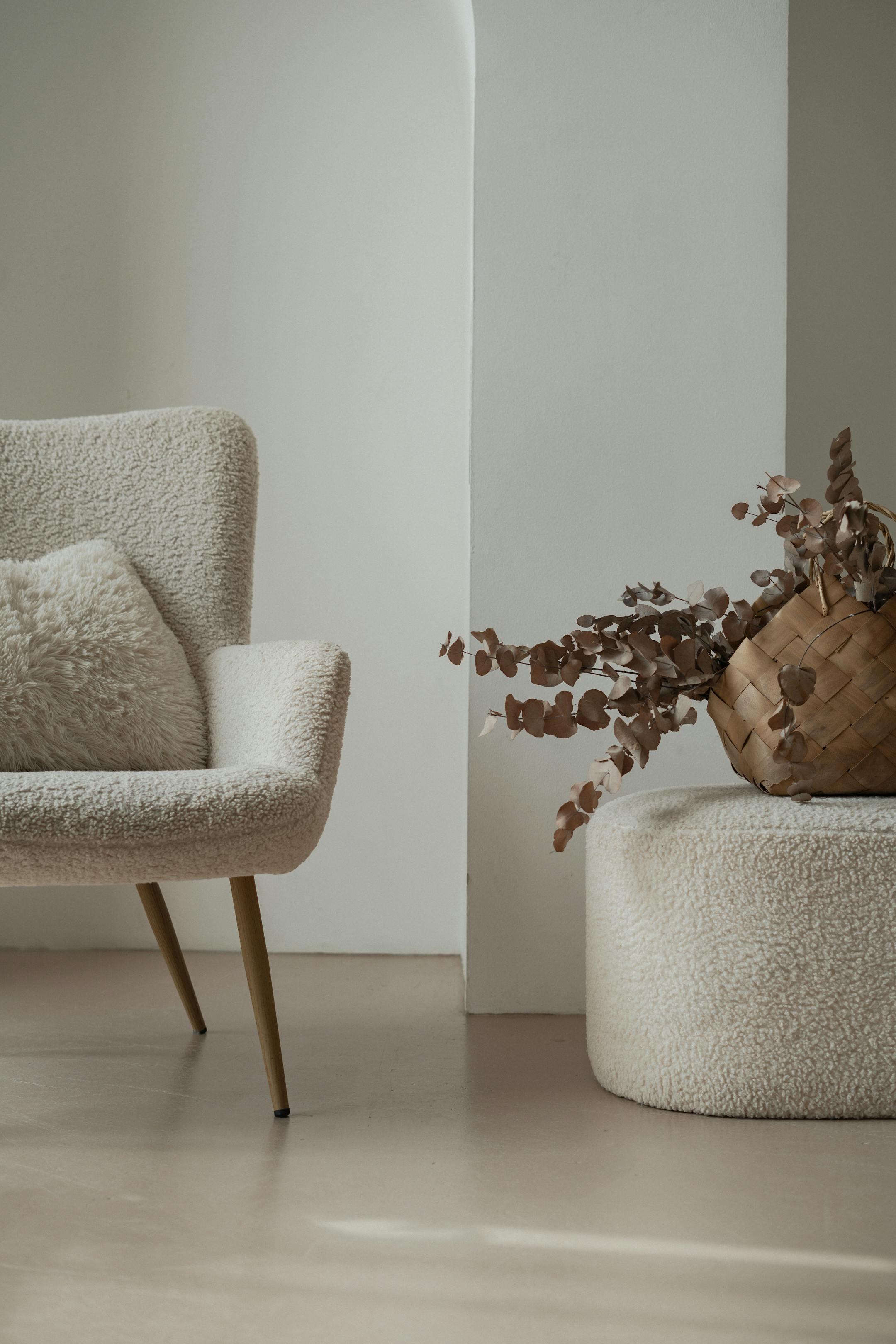 Serene minimalist living room featuring a soft fabric armchair and rustic decor elements.