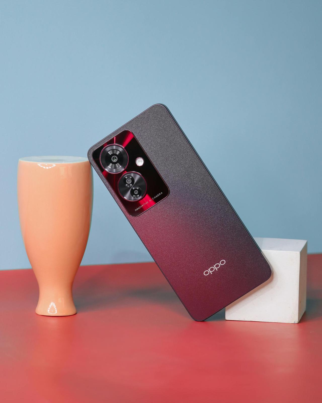 Stylish gadget on a colorful backdrop with a sleek vase, embodying modern technology and design.
