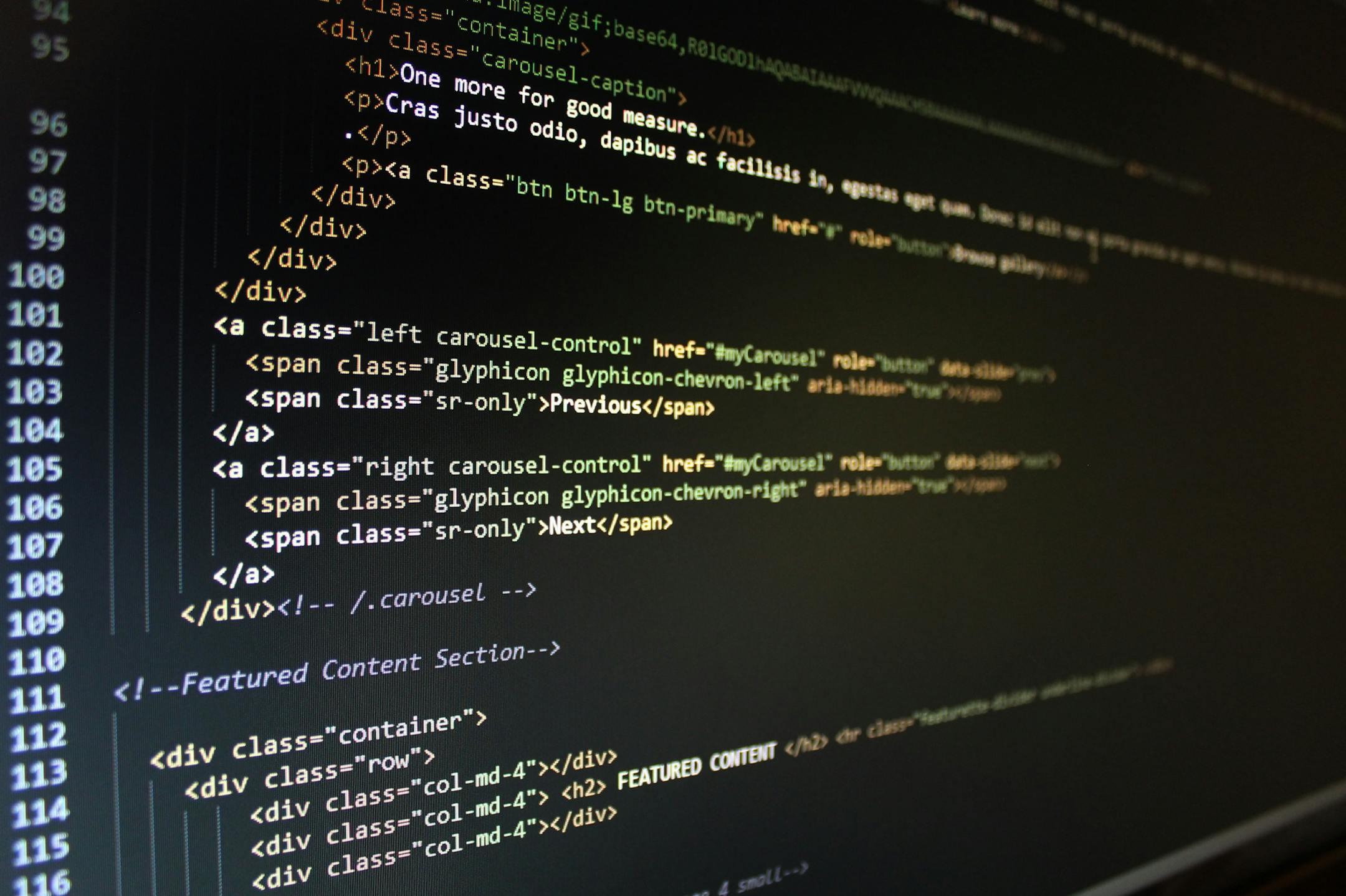 Close-up of HTML code displayed on a computer monitor, showcasing web development.