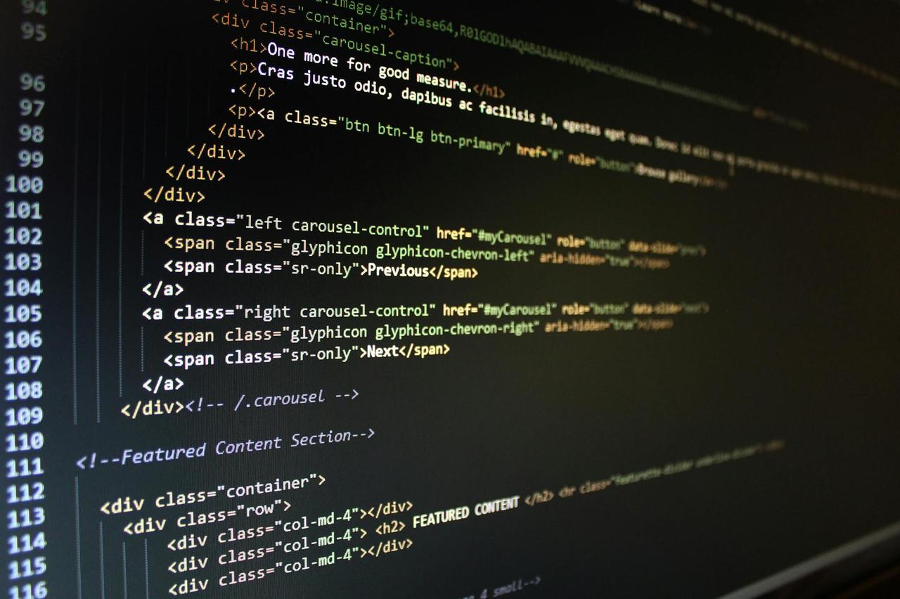 Close-up of HTML code displayed on a computer monitor, showcasing web development.