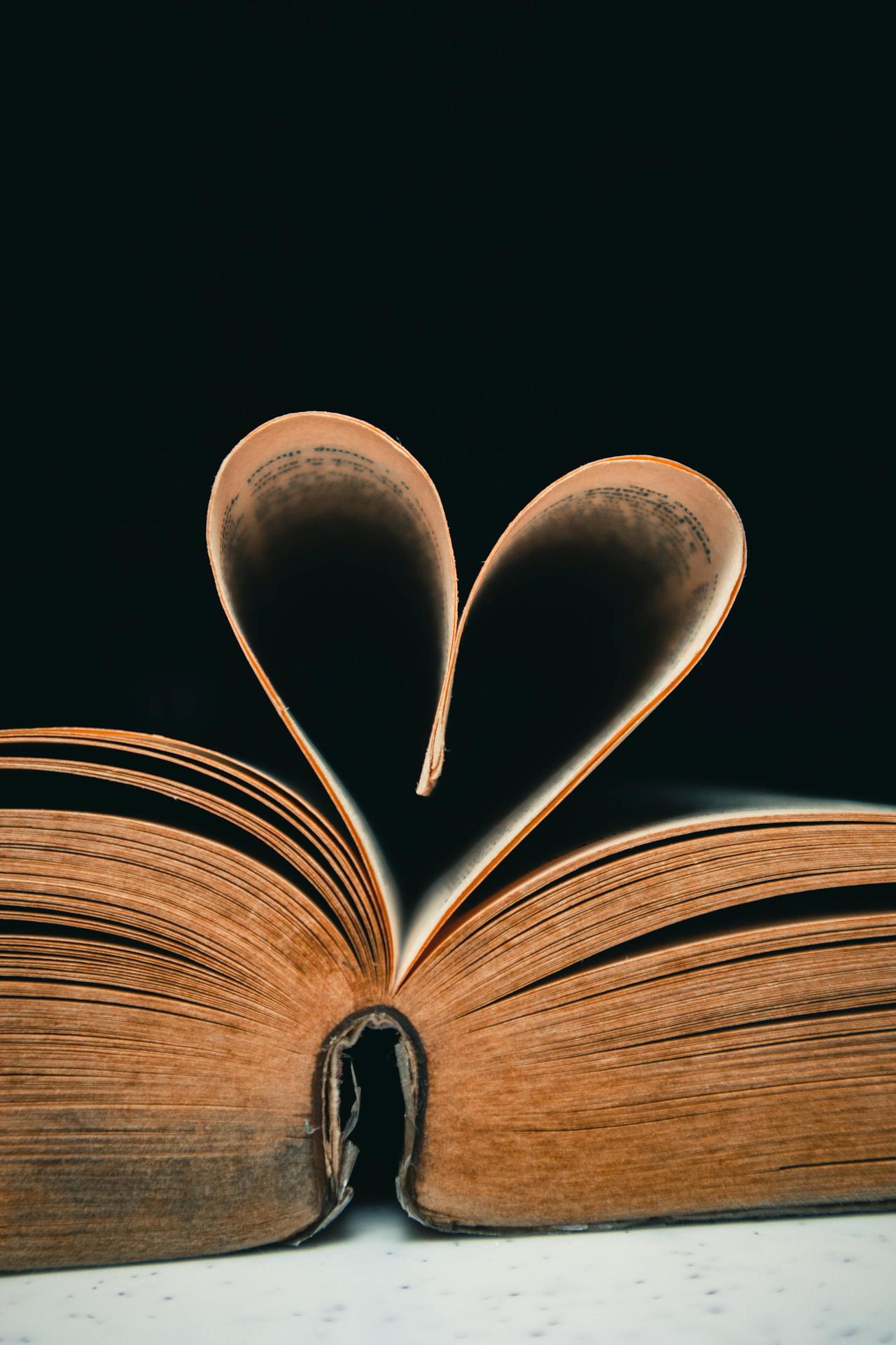 Book pages forming a heart shape, symbolizing love and romance in literature.