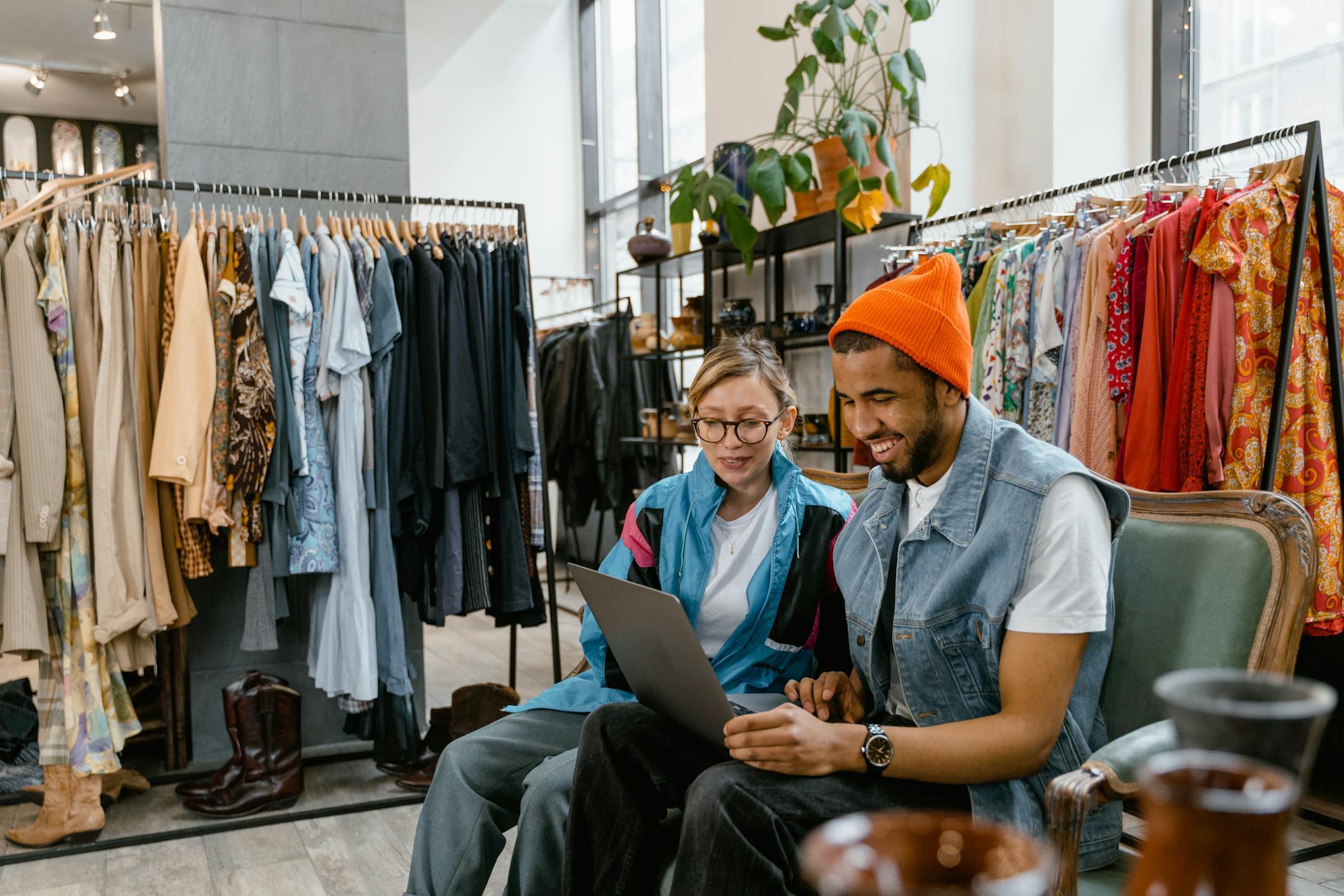 Two friends enjoying shopping in a stylish boutique. Smiles, fashion, and tech meet.