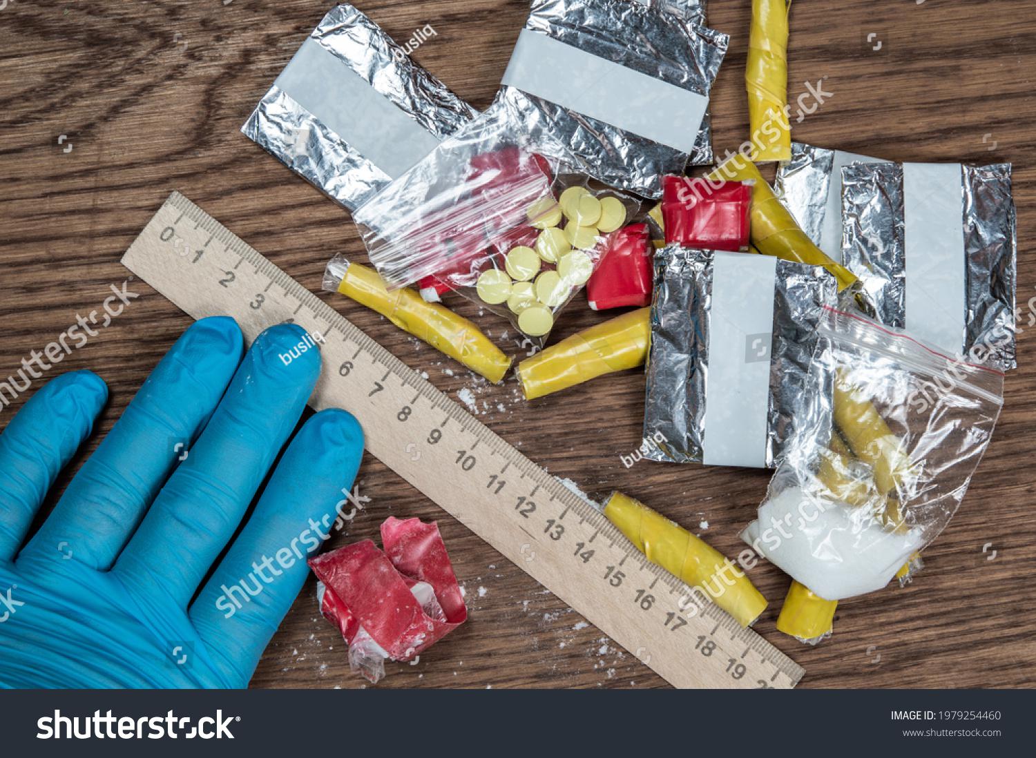 stock-photo-evidence-of-smuggling-traffic-packages-of-unknown-drugs-next-to-the-forensic-scale-1979254460.jpg