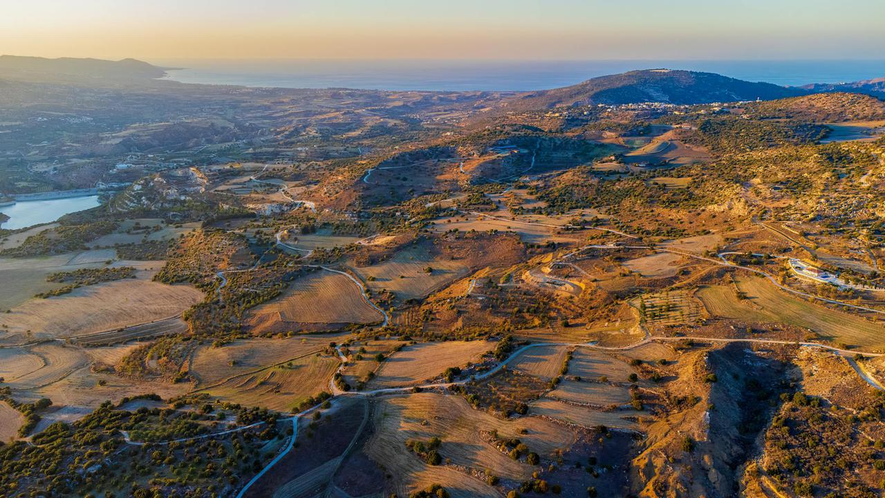 A breathtaking aerial view of a Mediterranean countryside landscape during sunset.