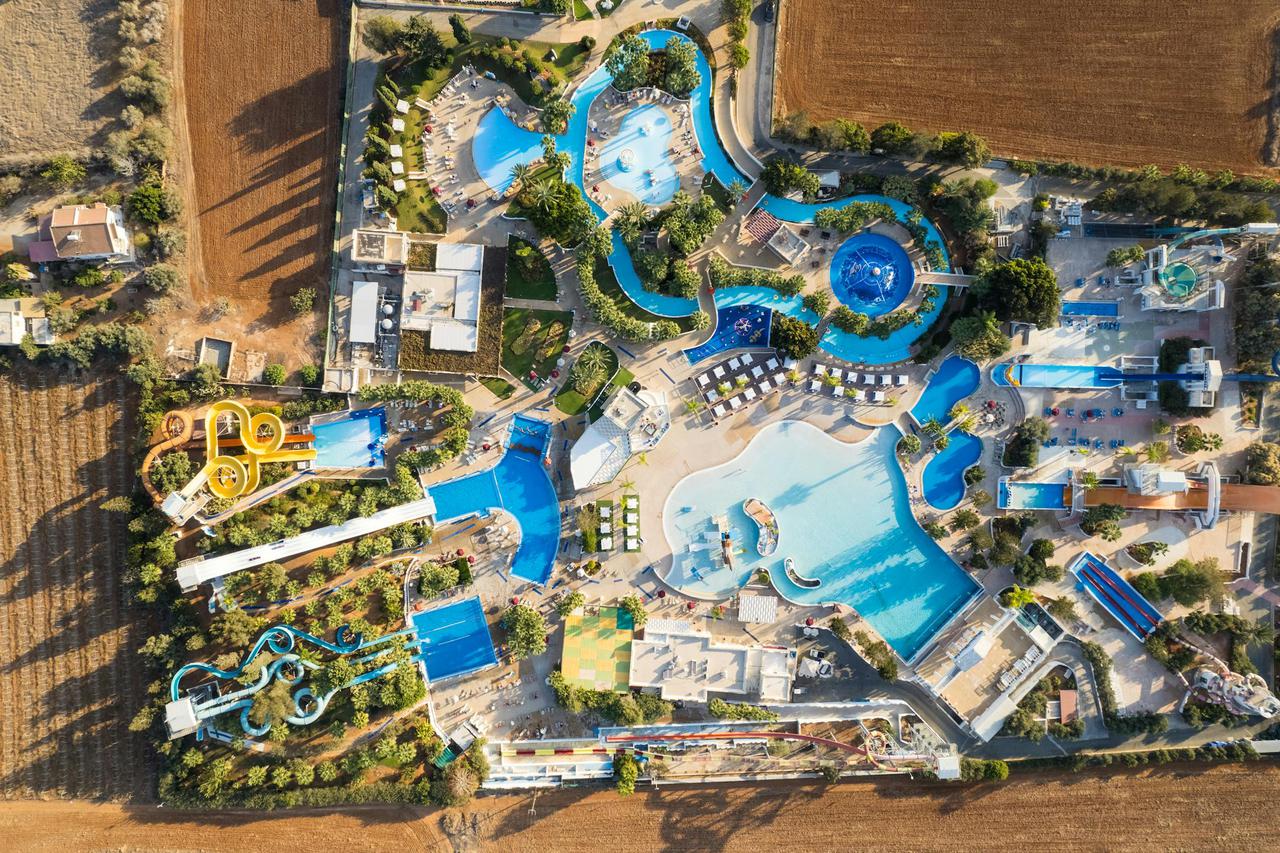 Stunning aerial view of a colorful water park in Ayia Napa, Cyprus, featuring various pools and slides.