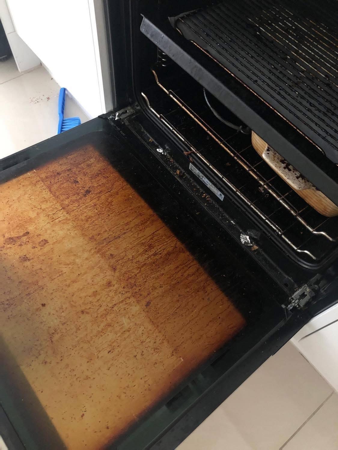 Oven interior heavily soiled with grease buildup before professional cleaning