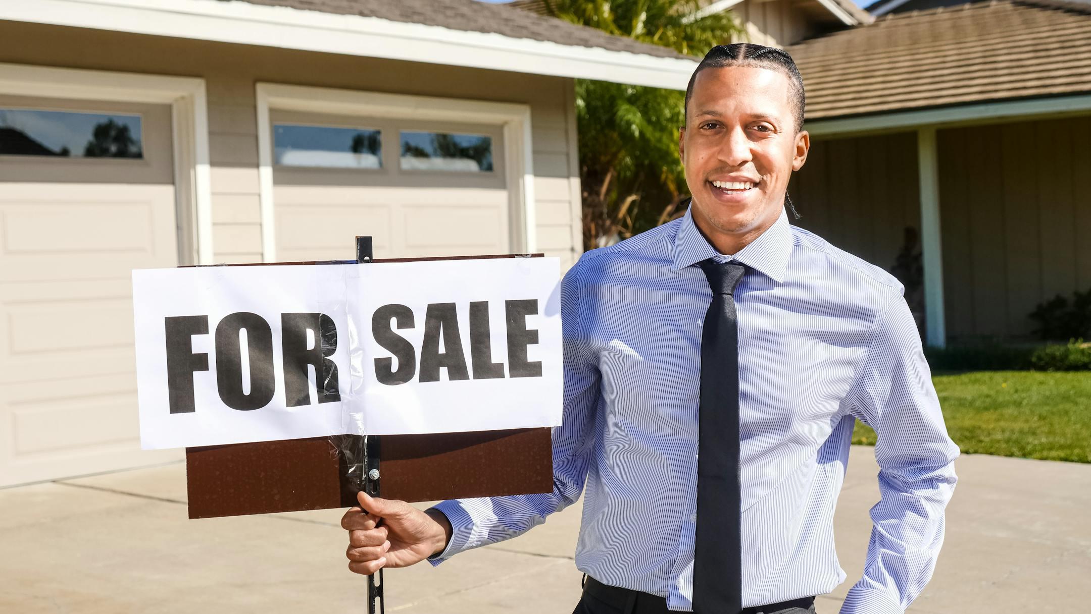 Smiling real estate agent who used a real estate title company to complete a sale