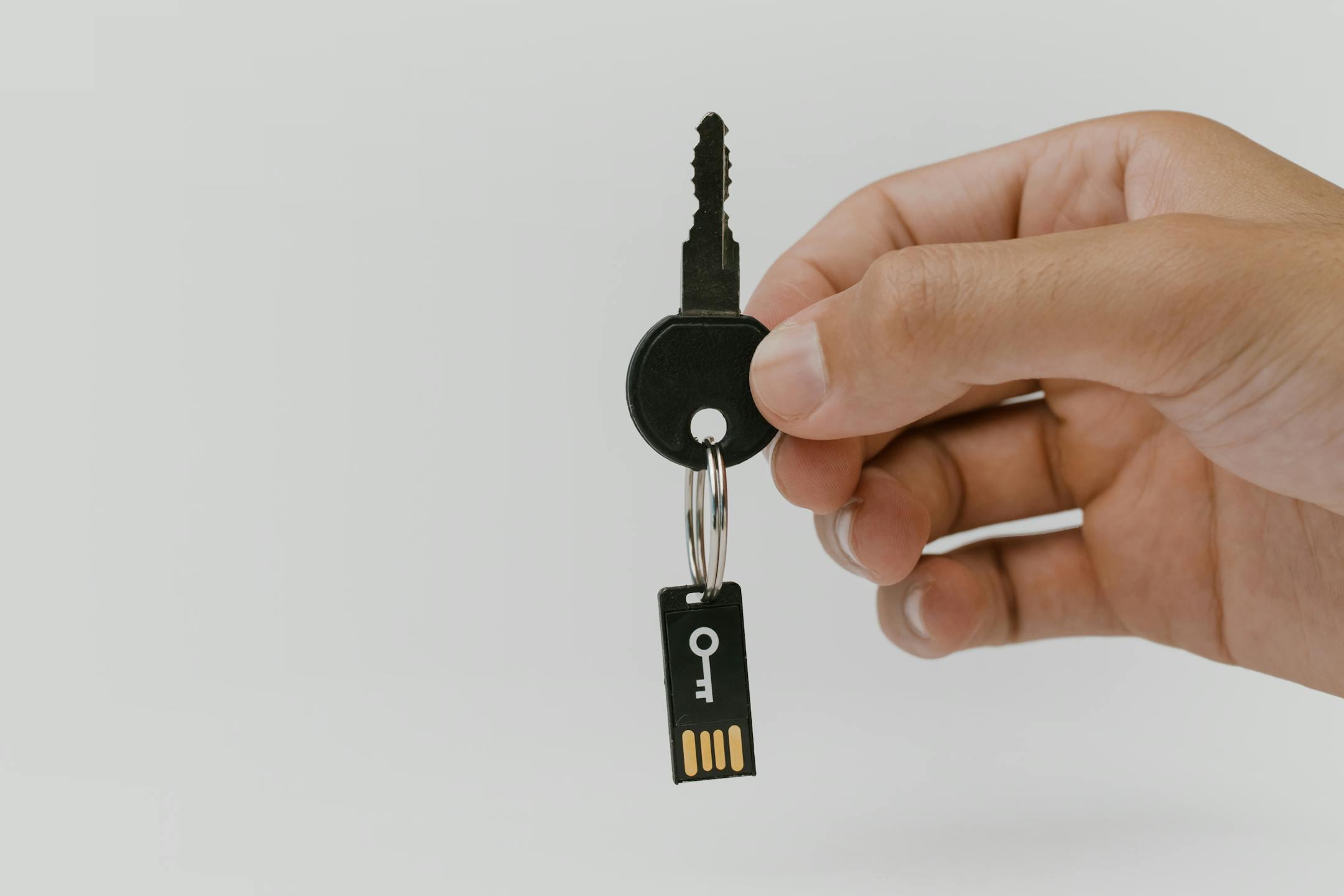A close-up of a hand holding a key representing title security in Nevada