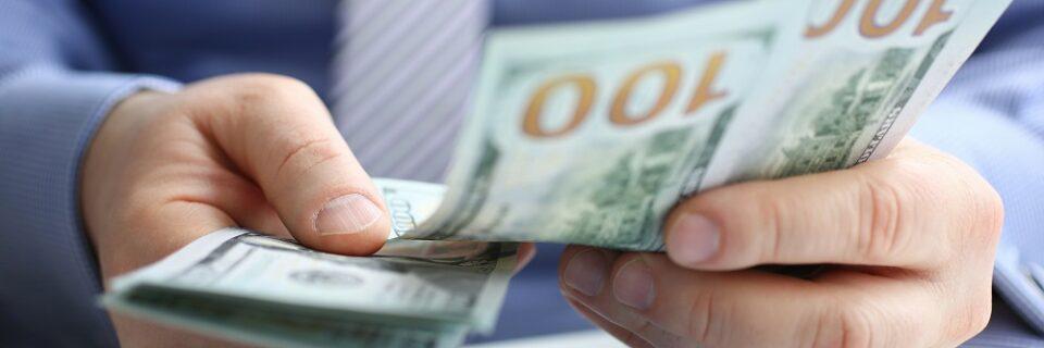 man-counting-out-money-adobestock_295424263-960x320.jpg