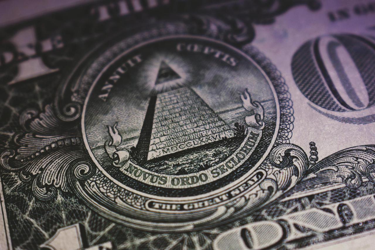 Detailed close-up of US dollar bill showing the Eye of Providence and pyramid design.