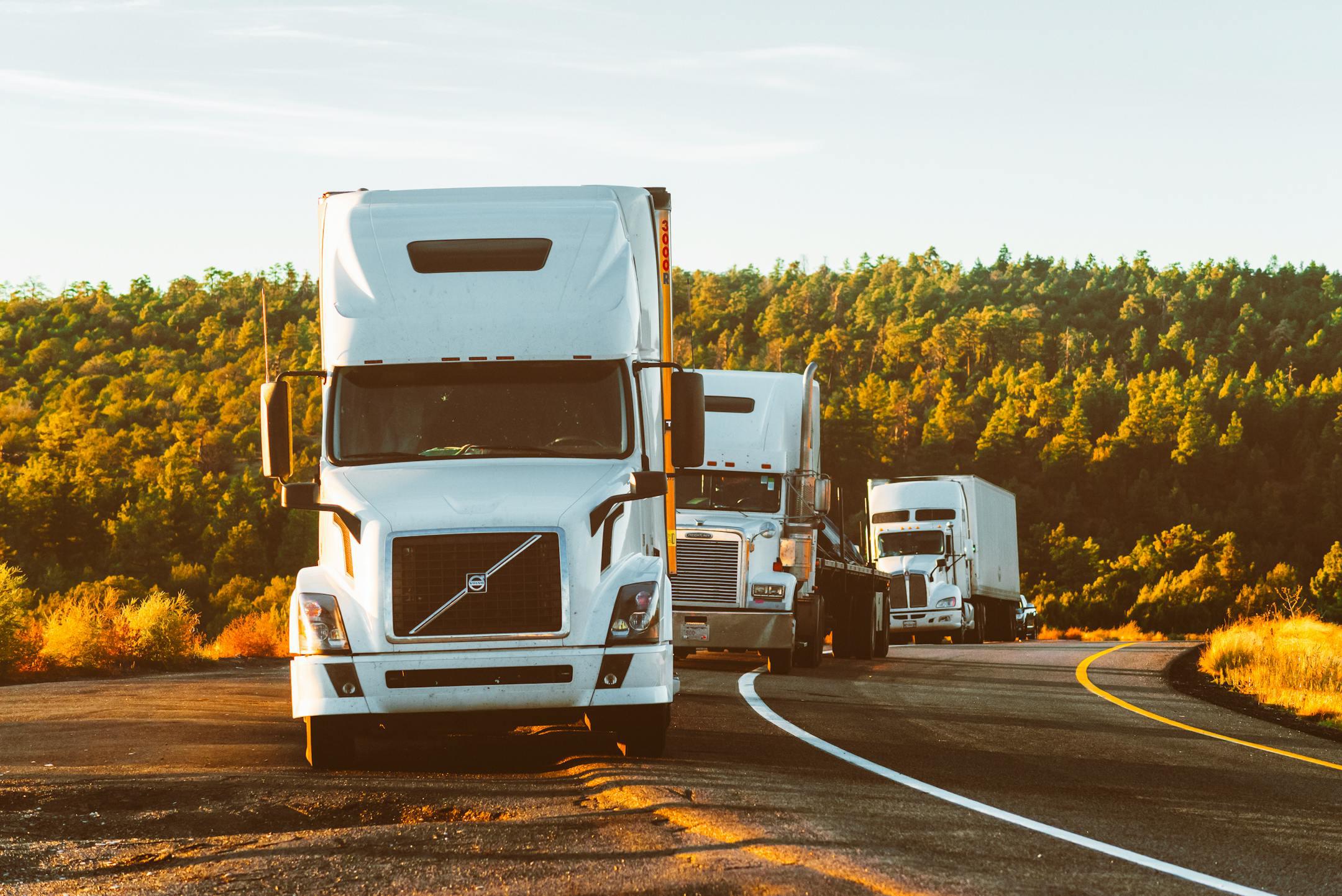 Three semi trucks that partner with Gold Star Transportation, a freight management and logistics company that prioritizes careful carrier vetting