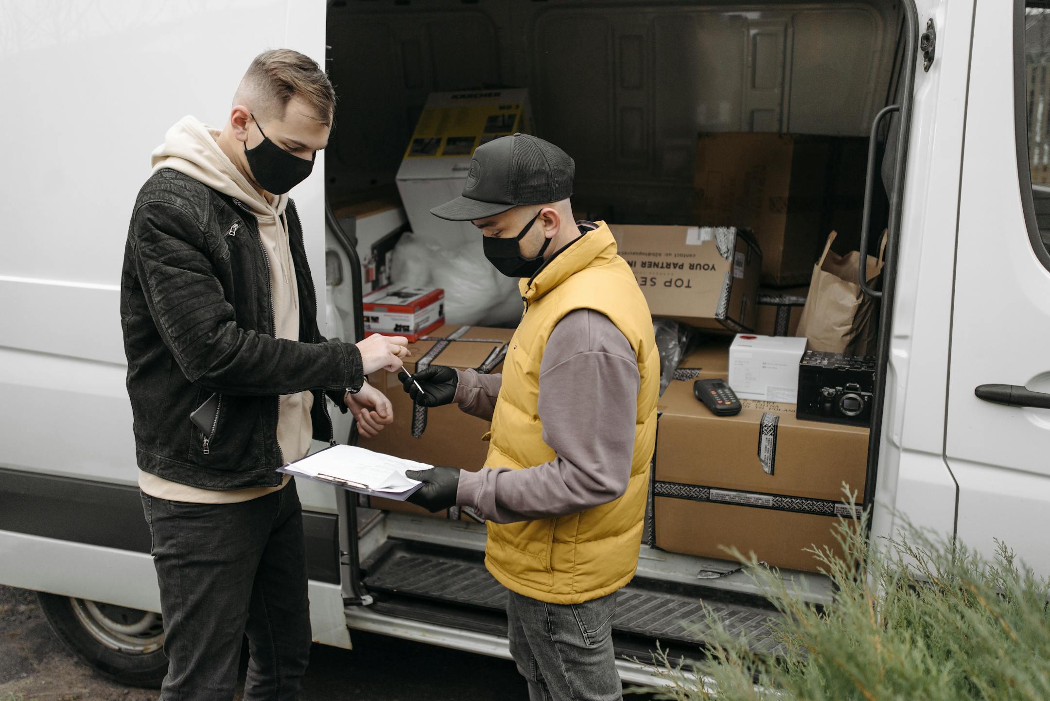 Courier wearing face mask delivers packages to a customer with expedited shipping