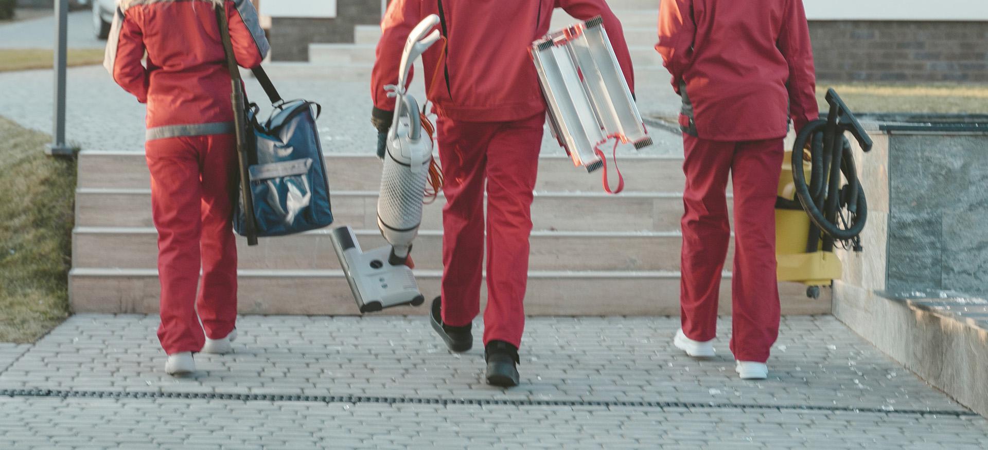 A group of cleaners entering a small business.