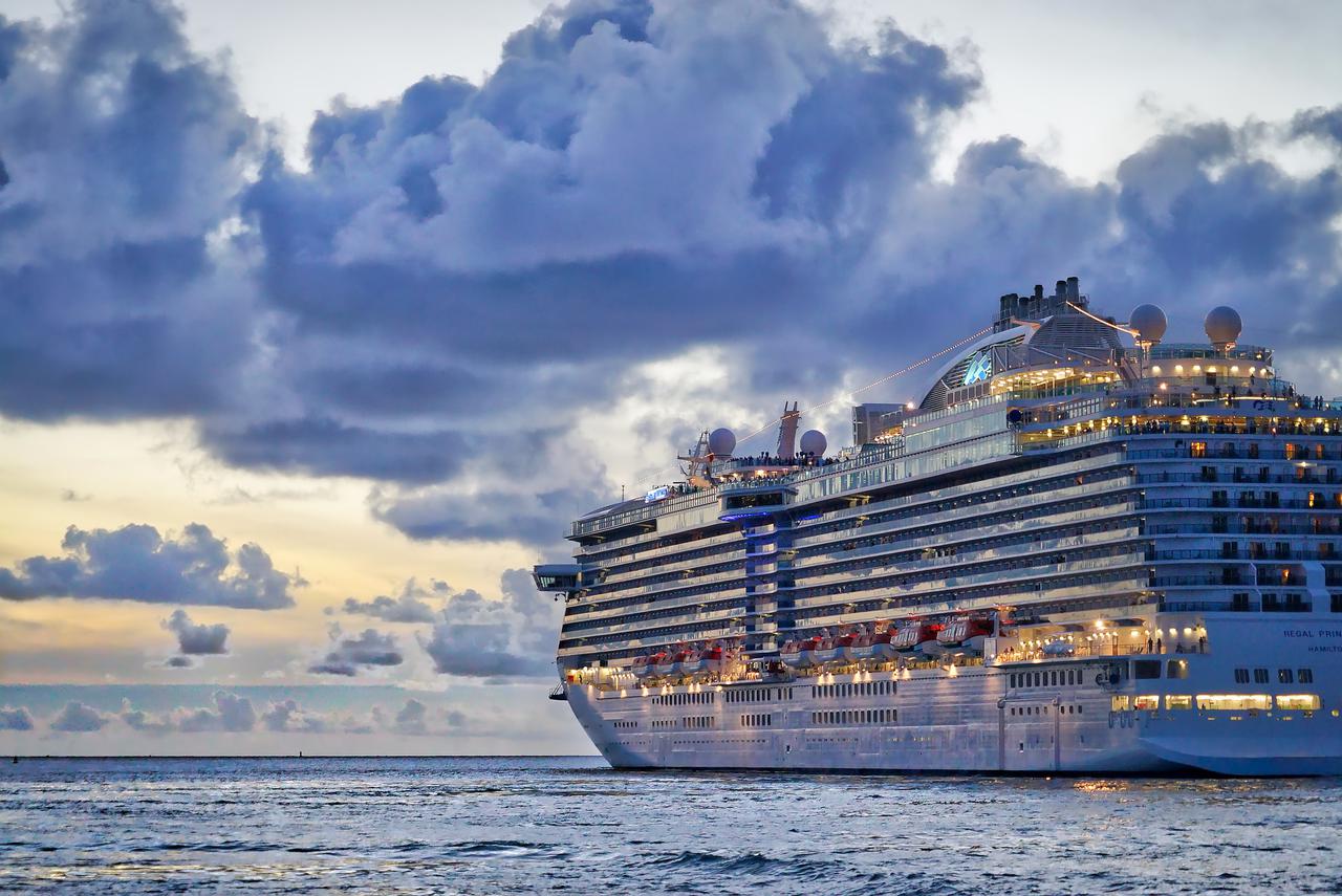 cruise ship on the ocean at sunset