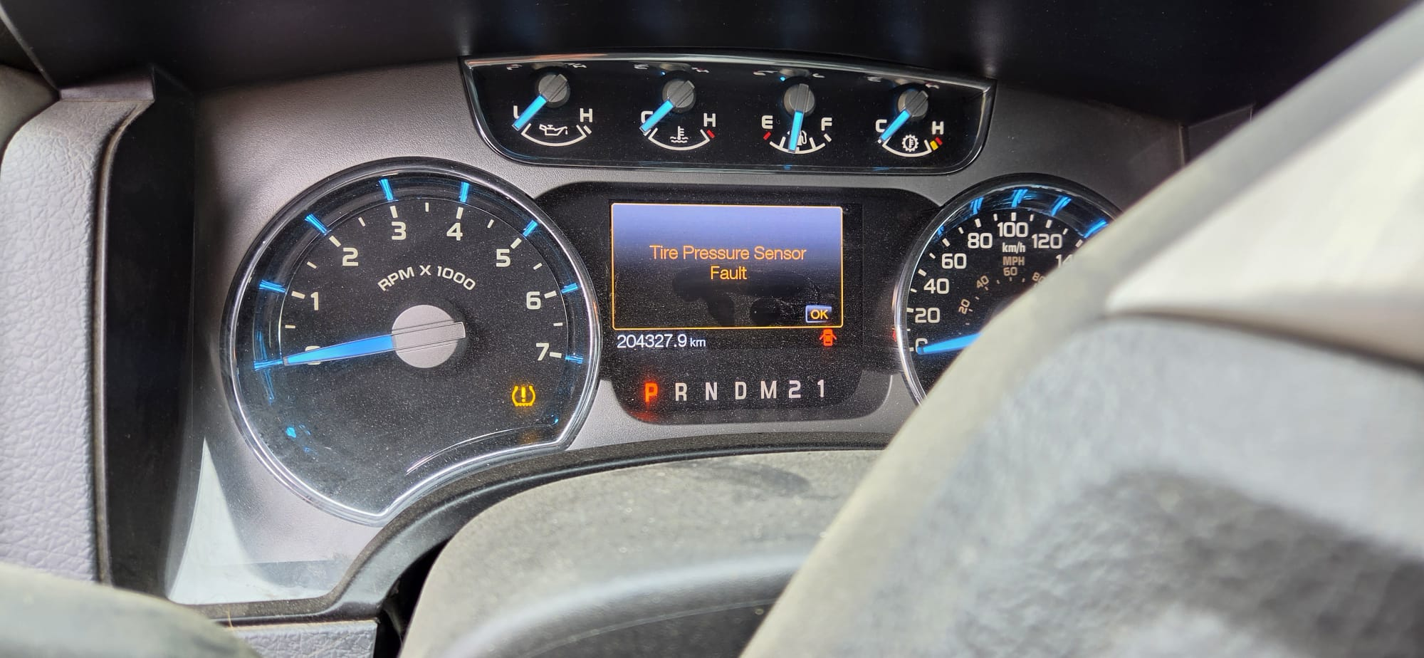 Instrument cluster showing 204,327.9 km