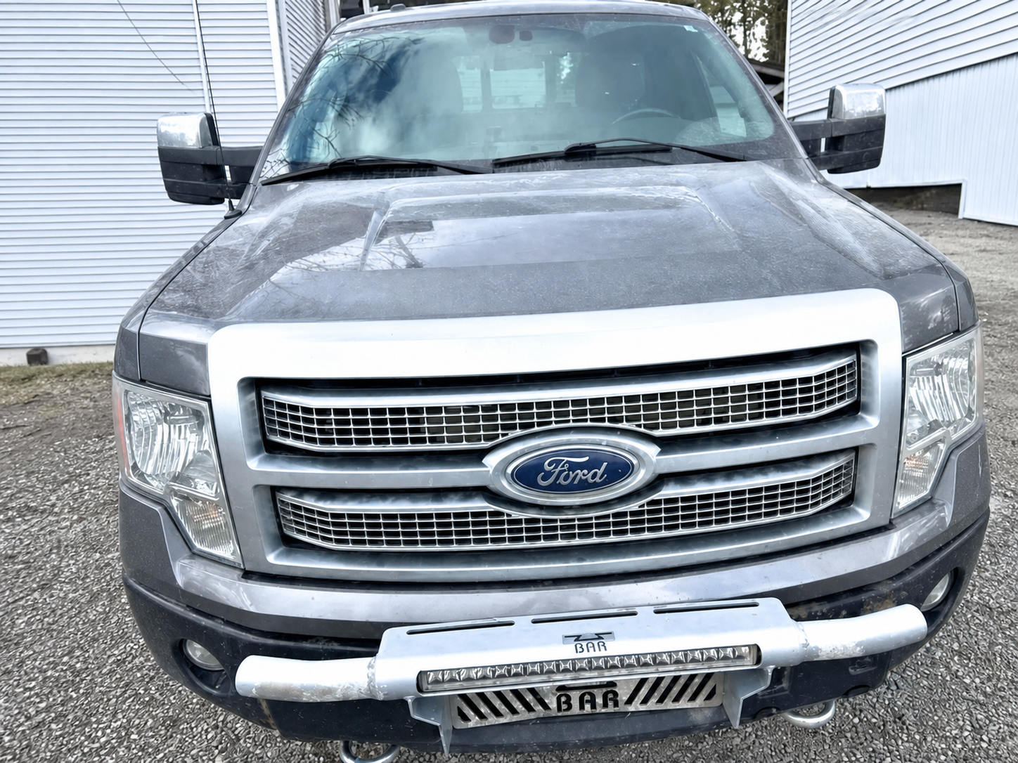 Front view of 2012 Ford F-150 Platinum with front protection bar and auxiliary light