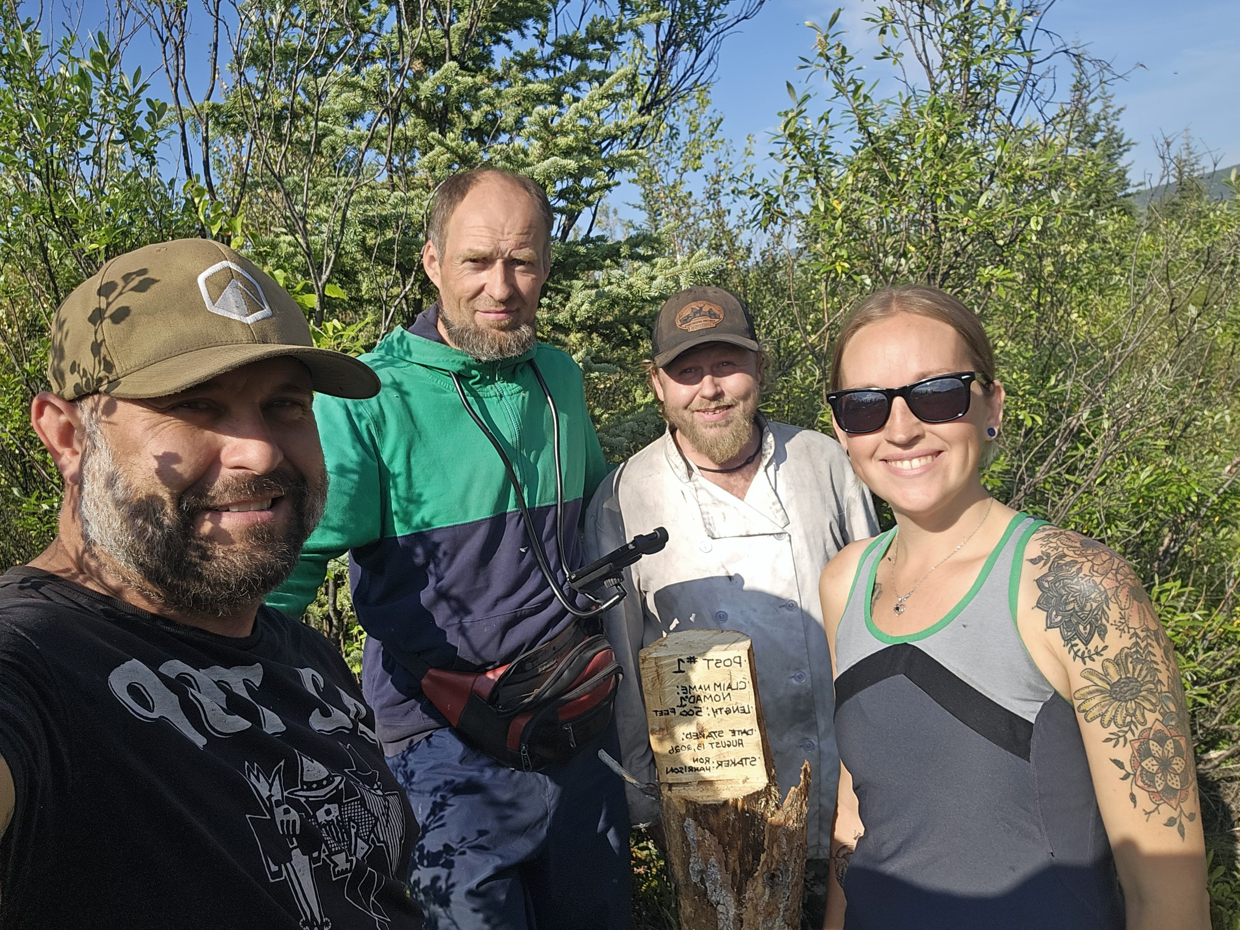 Klondike Revival field crew standing beside a claim post