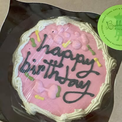 Pink frosted cookie decorated with a Happy Birthday message