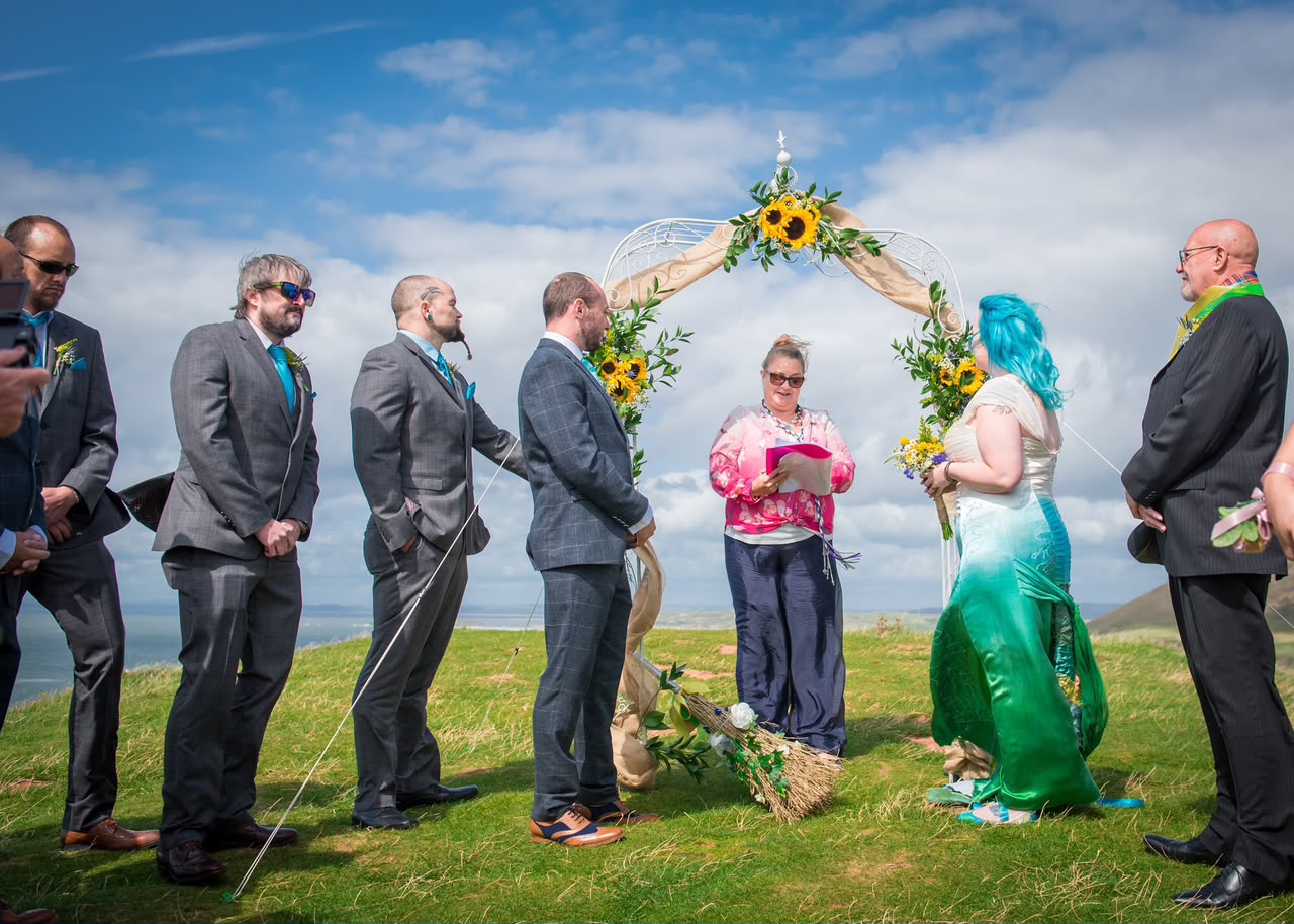 Claire Mountain leading an outdoor hillside wedding ceremony