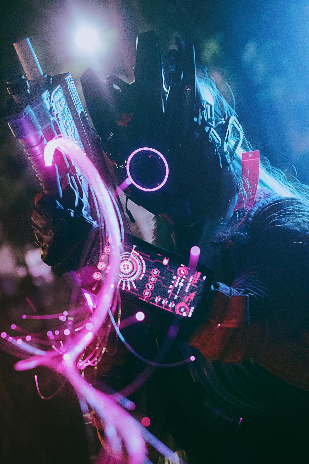 A cyberpunk warrior in futuristic armor glowing with holographic lights.