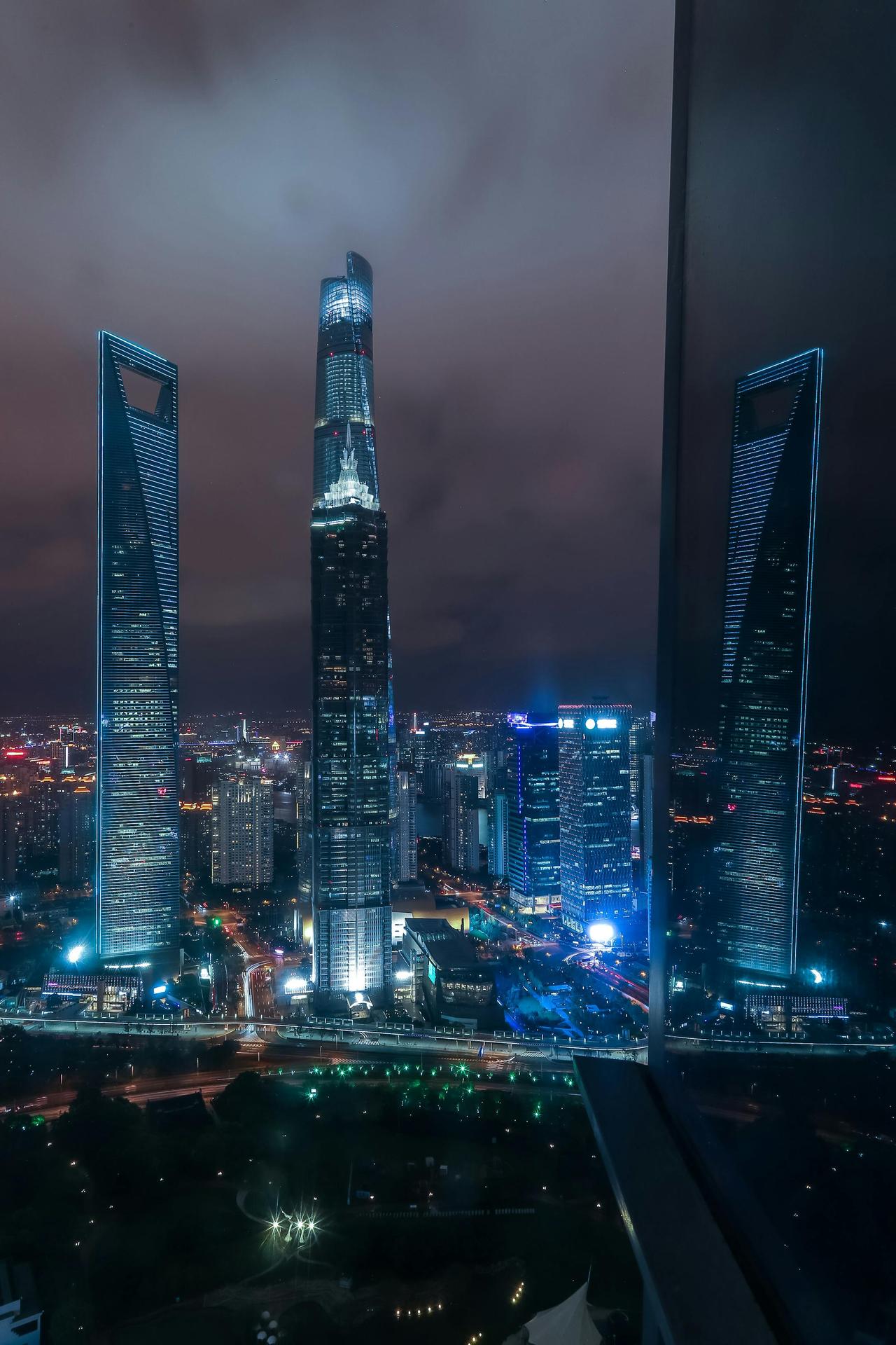 Breathtaking view of Shanghai's illuminated skyscrapers at night, showcasing modern architecture.