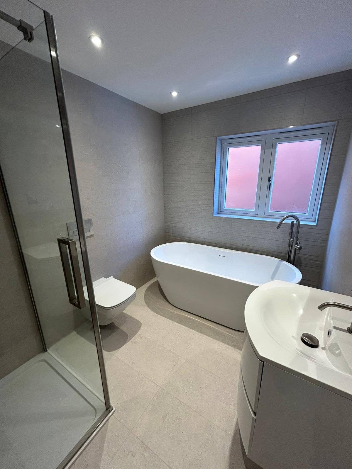 Luxury bathroom tiling in Solihull with walk-in shower, freestanding bath, and full wall tiling