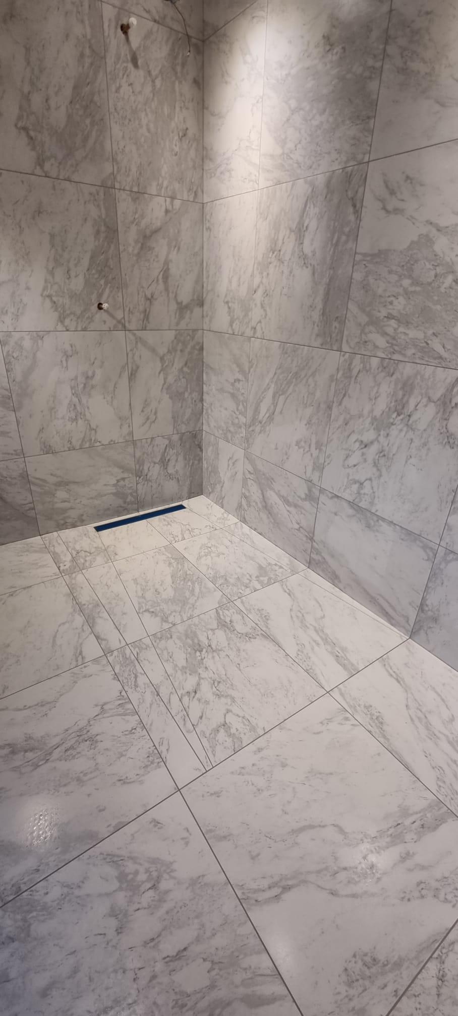 Full wet room installation in Coventry with walk-in shower, Large-format marble tiles and fully waterproofed finish
