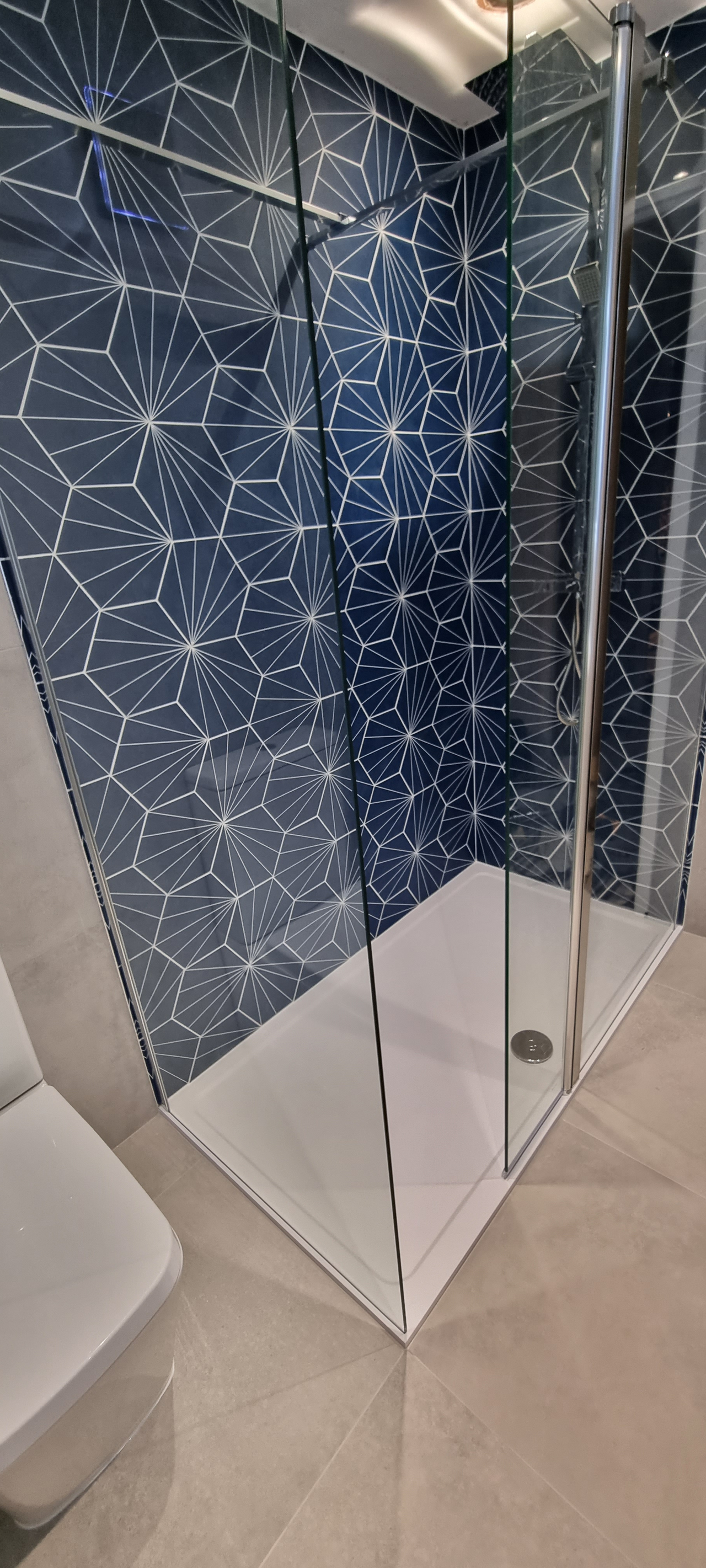 Specialist wall tiling in Coventry - bathroom wall with heaxagon tiles and a flawless wrap into the next wall
