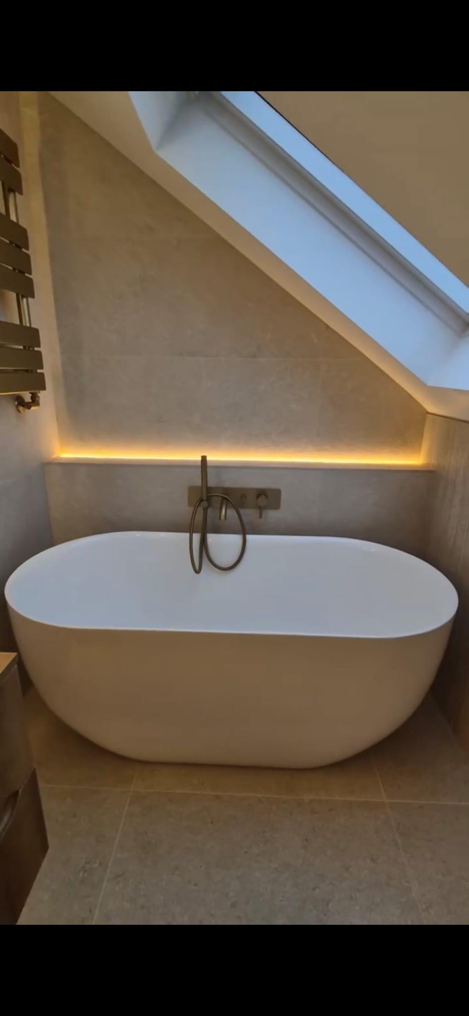 Large format tiling with integrated LED lighting above freestanding bath, Coventry Tiling