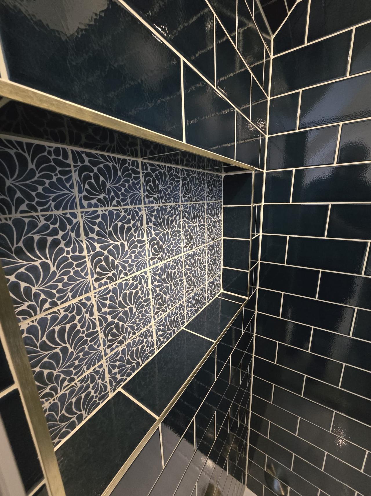 Dark blue brick-effect tiling with crackle-glaze feature niche in shower, Coventry Tiling