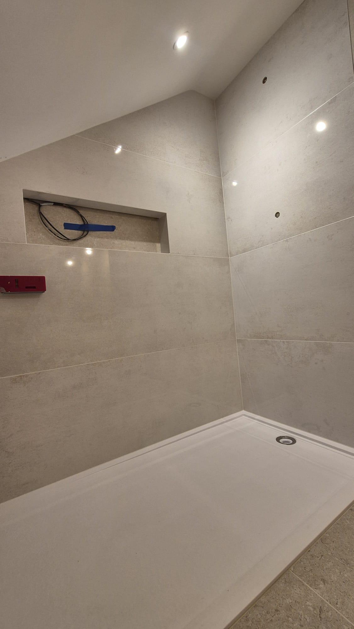 Epoxy mitred shower niche installed in a luxury walk-in shower with large dormat porcelain tiles, seamless mitred corners by Coventry Tiling specialist