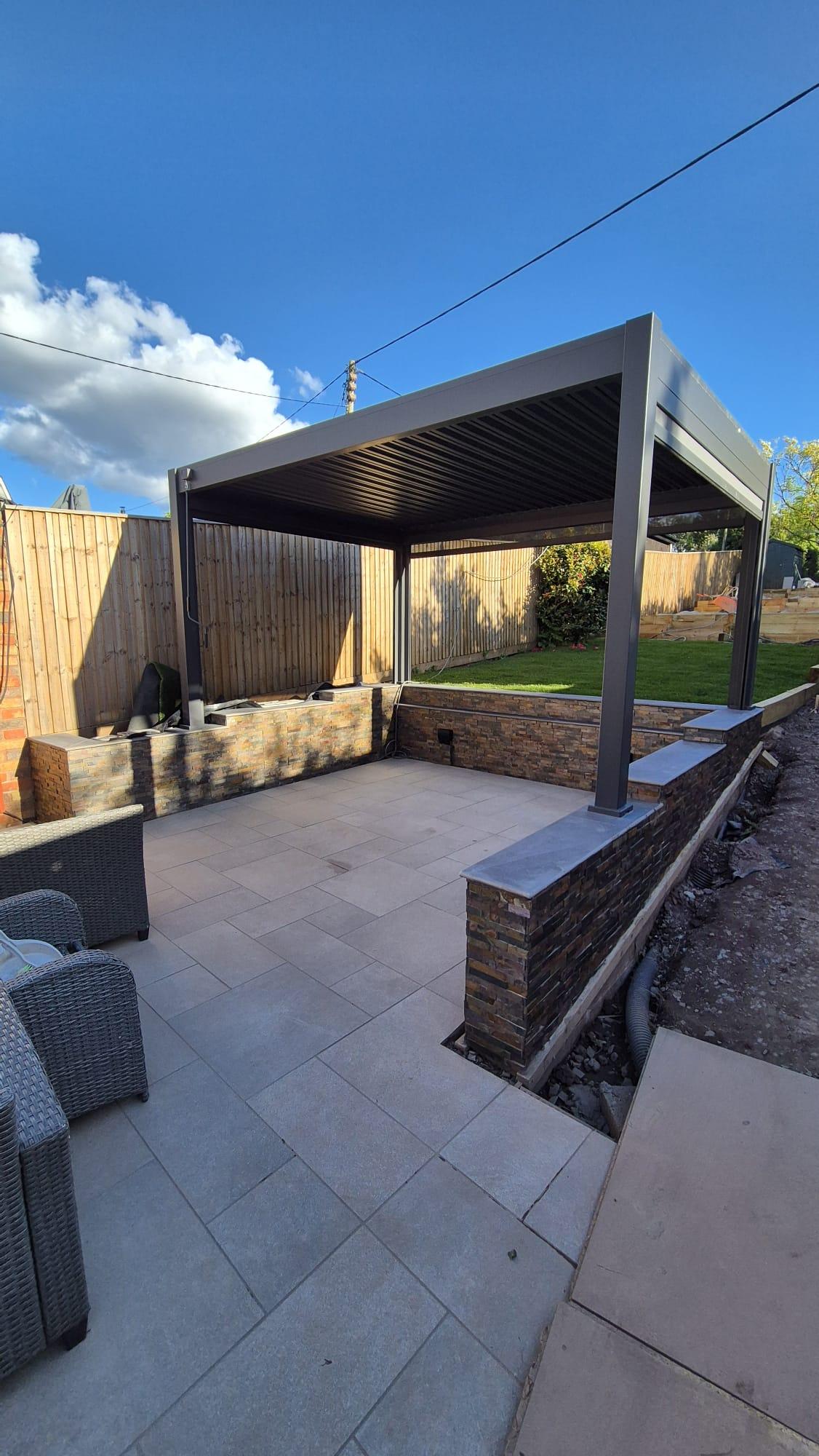 Split-face stone wall cladding on outdoor patio, Coventry Tiling
