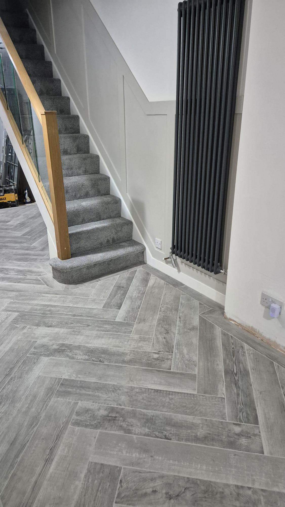 Grey herringbone tile flooring with staircase and slatted wall panelling, Coventry Tiling