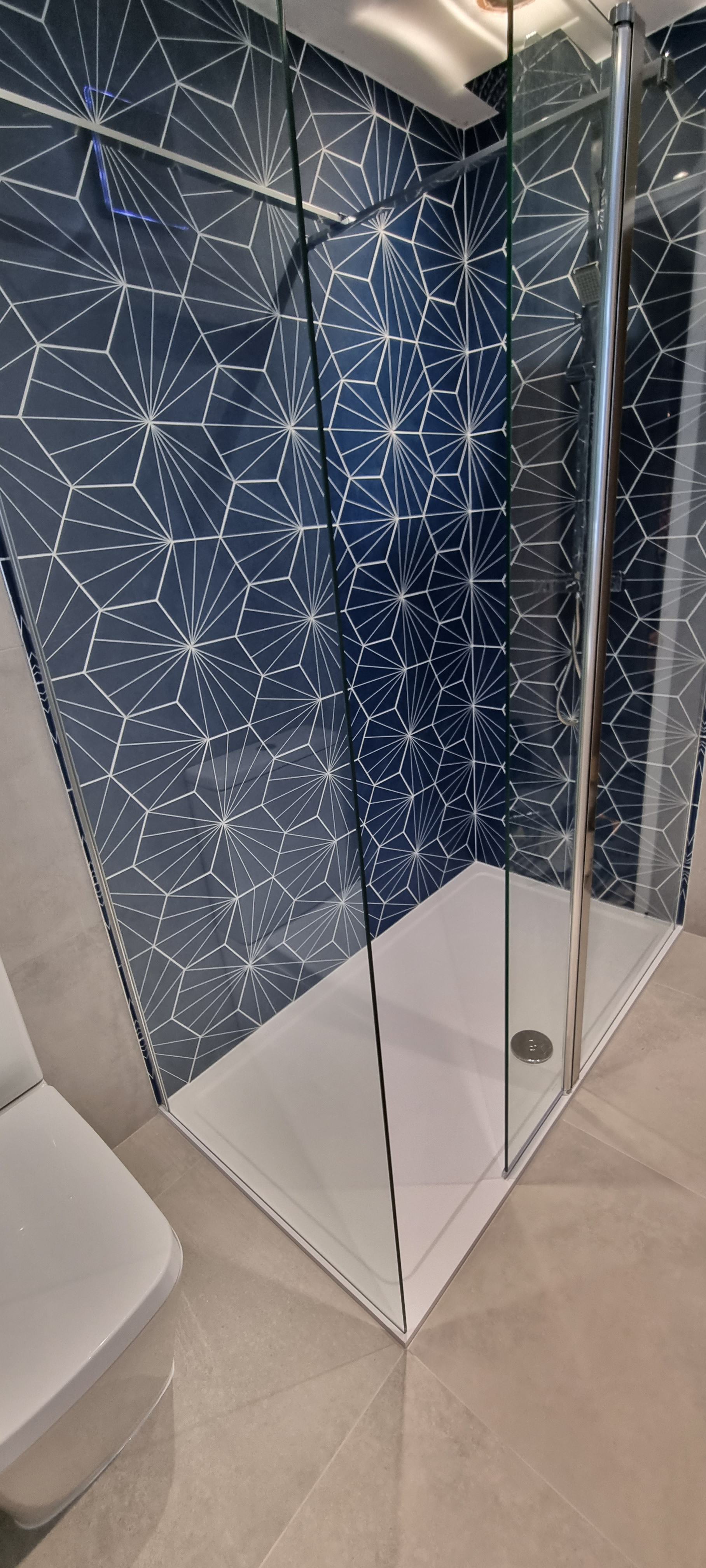Specialist wall tiling in Coventry - bathroom wall with heaxagon tiles and a flawless wrap into the next wall